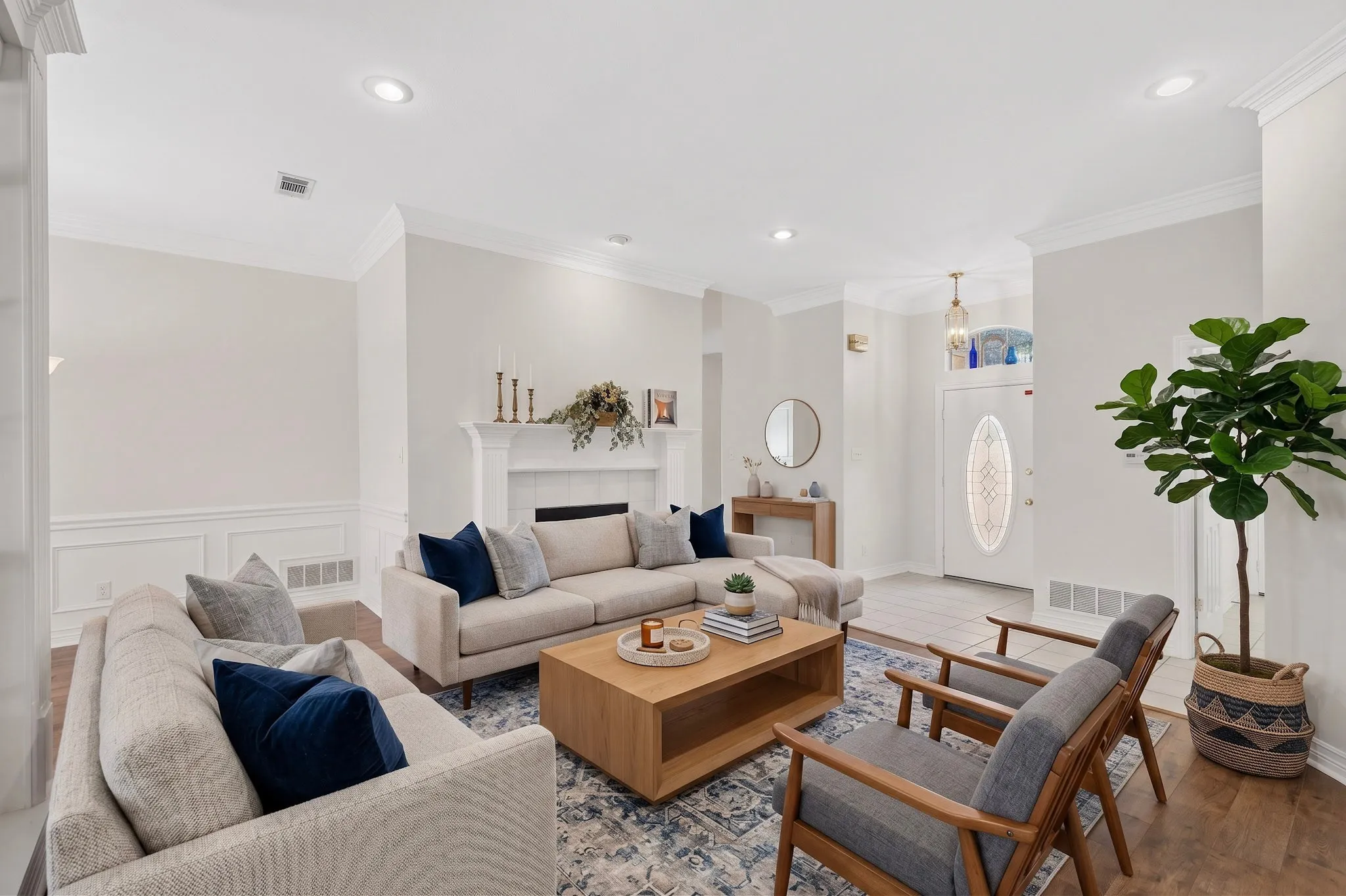Recessed lighting, crown molding, fireplace with mantel, wainscoting, and wood-finish flooring