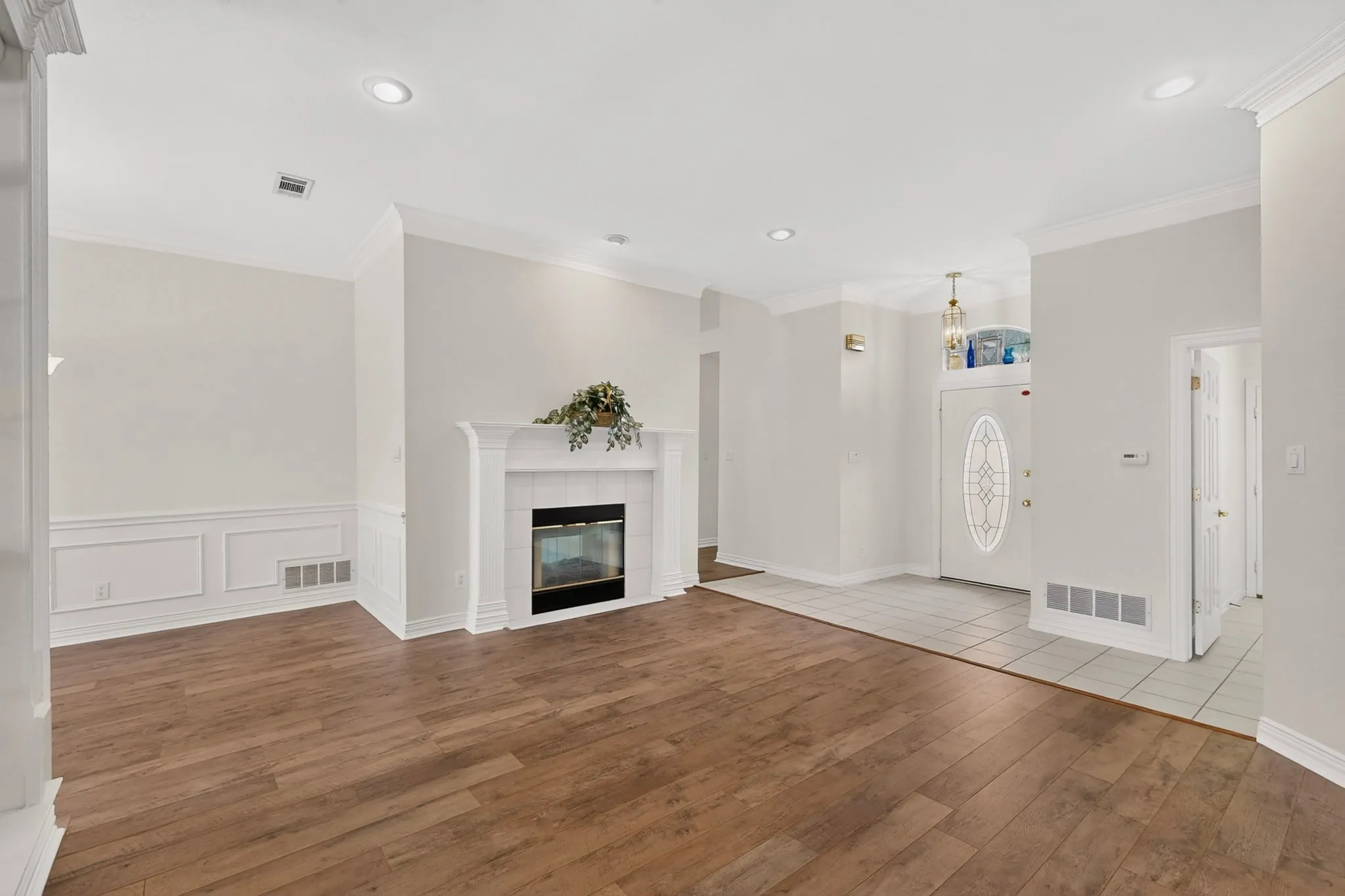 Kitchen featuring white cabinetry, light-toned countertops, a white subway tile backsplash, and tile flooring