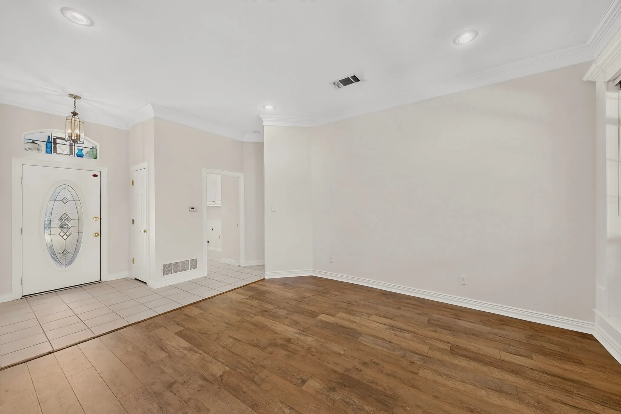Kitchen featuring white cabinetry, light-toned countertops, a white subway tile backsplash, and tile flooring