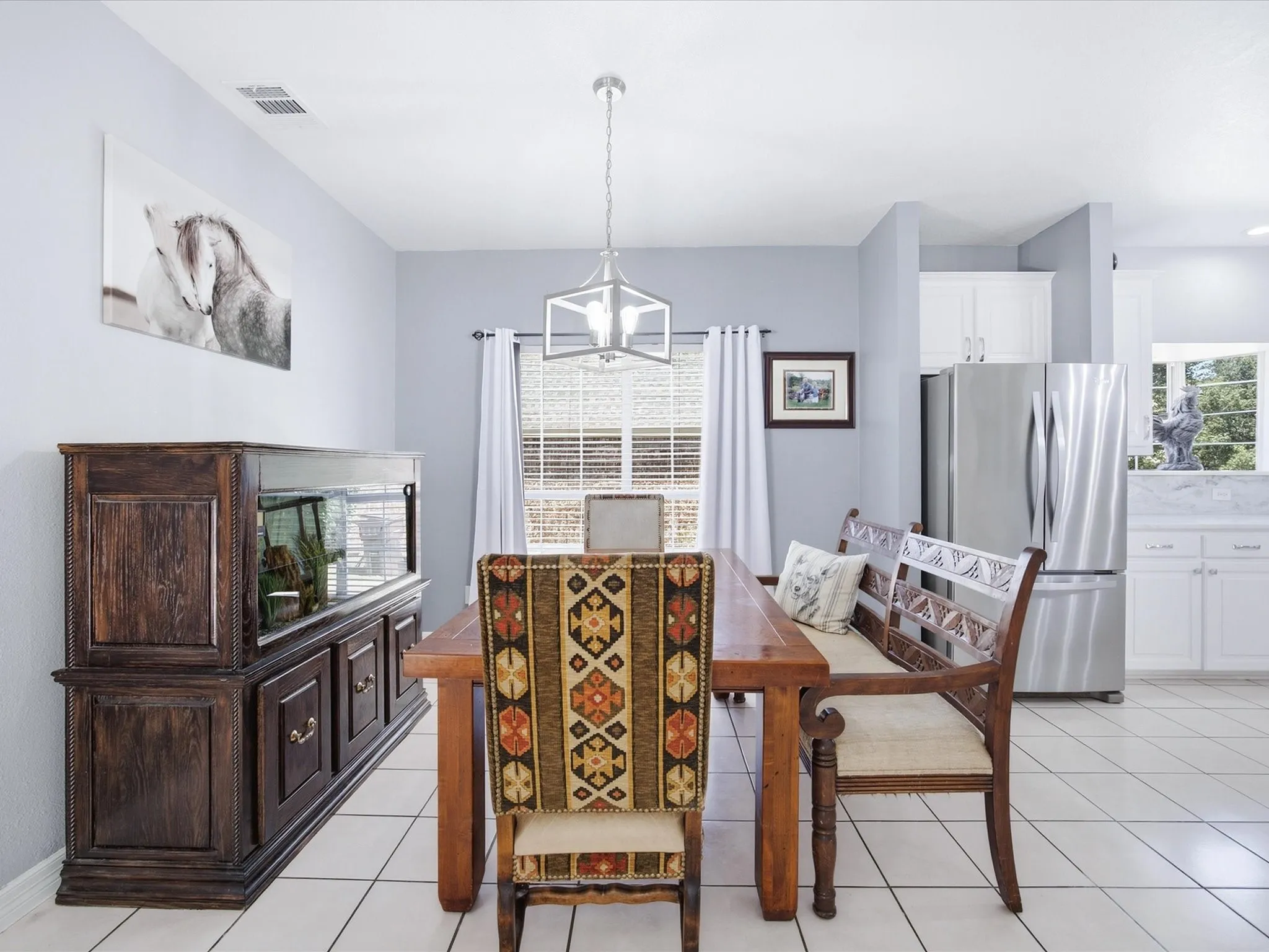 Tile flooring throughout, recessed lighting, and a modern rectangular chandelier