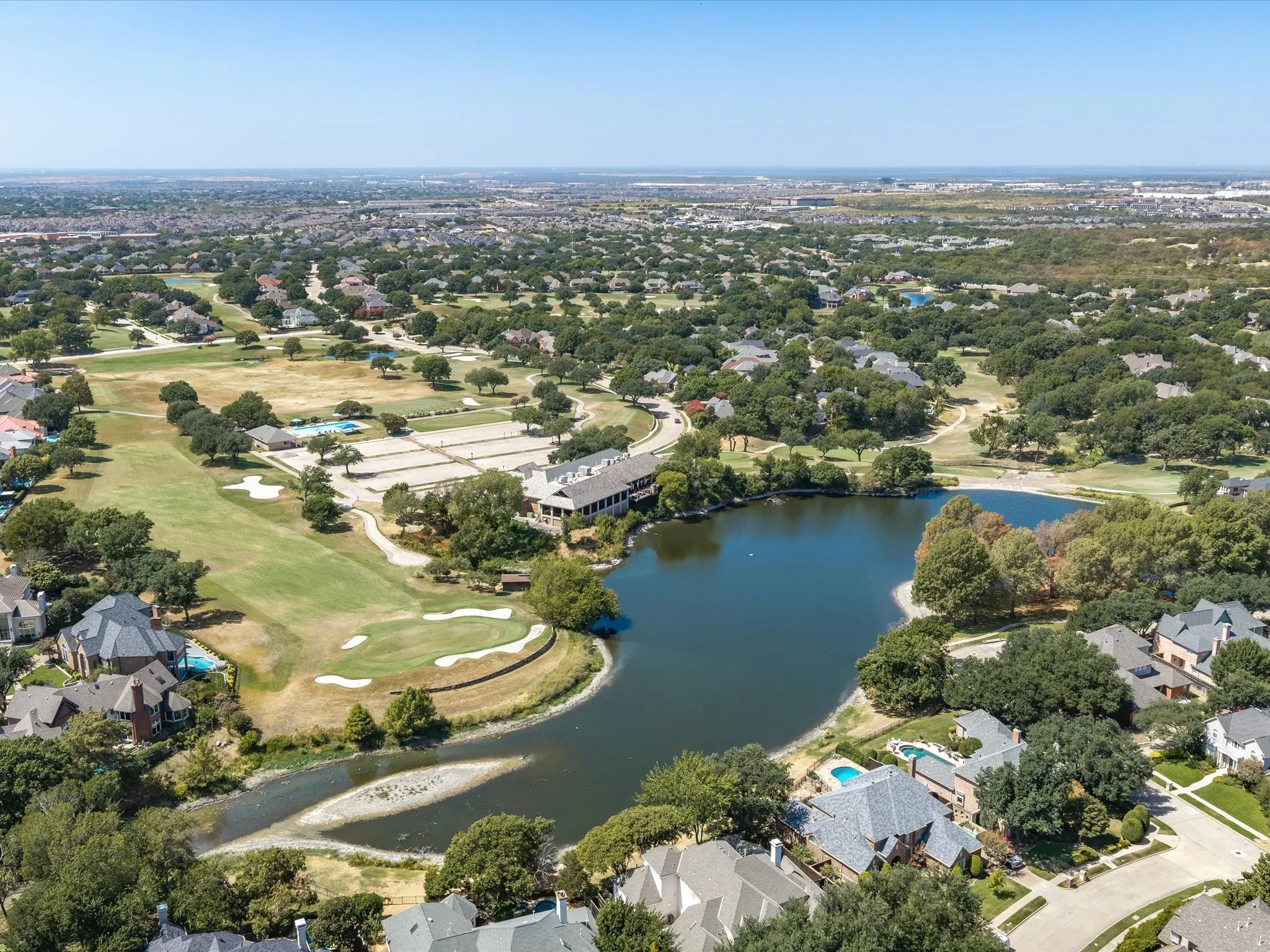 Lakeside community golf course featuring mature trees