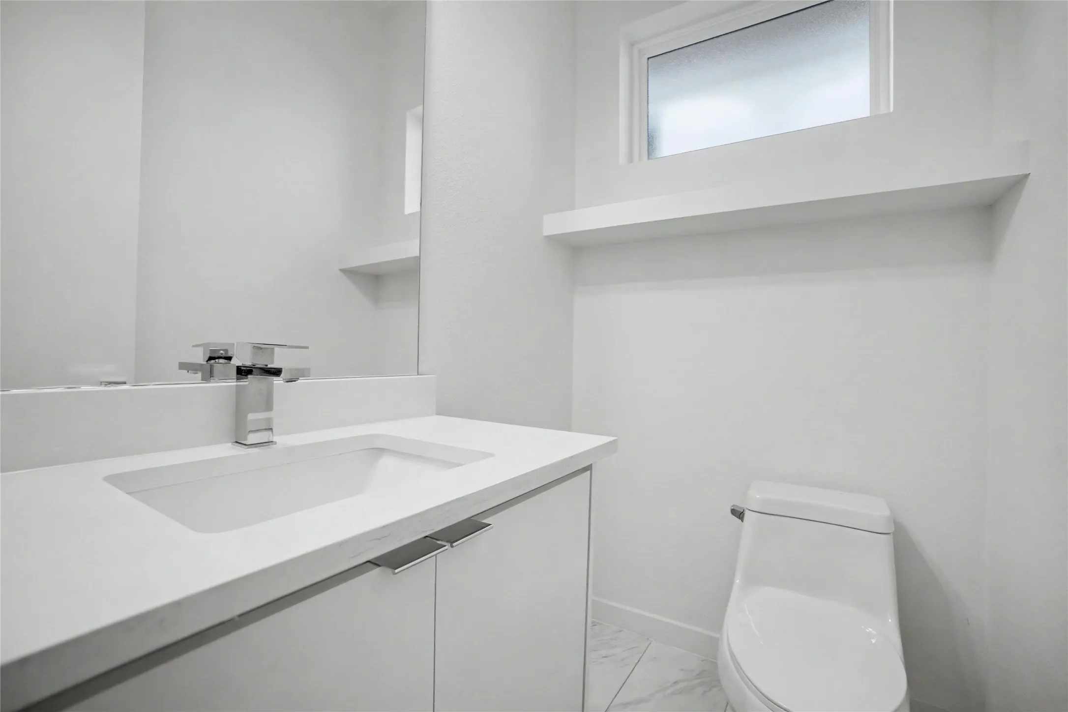 Integrated sink and countertop with sleek cabinetry and polished chrome faucet