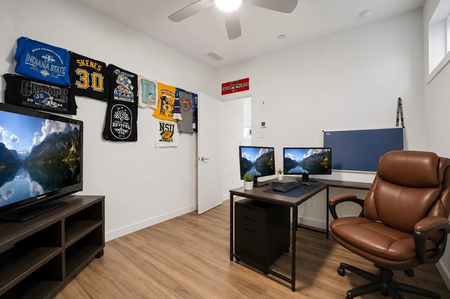 Wood-finish flooring with white walls and a ceiling fan