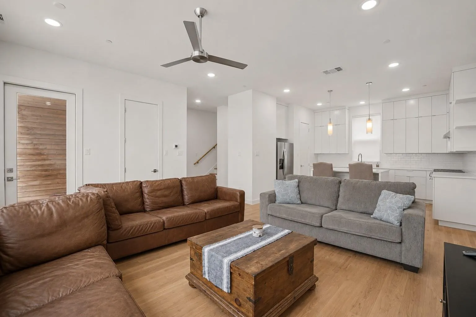 Open concept living space with wood-finish flooring, recessed lighting, and a ceiling fan