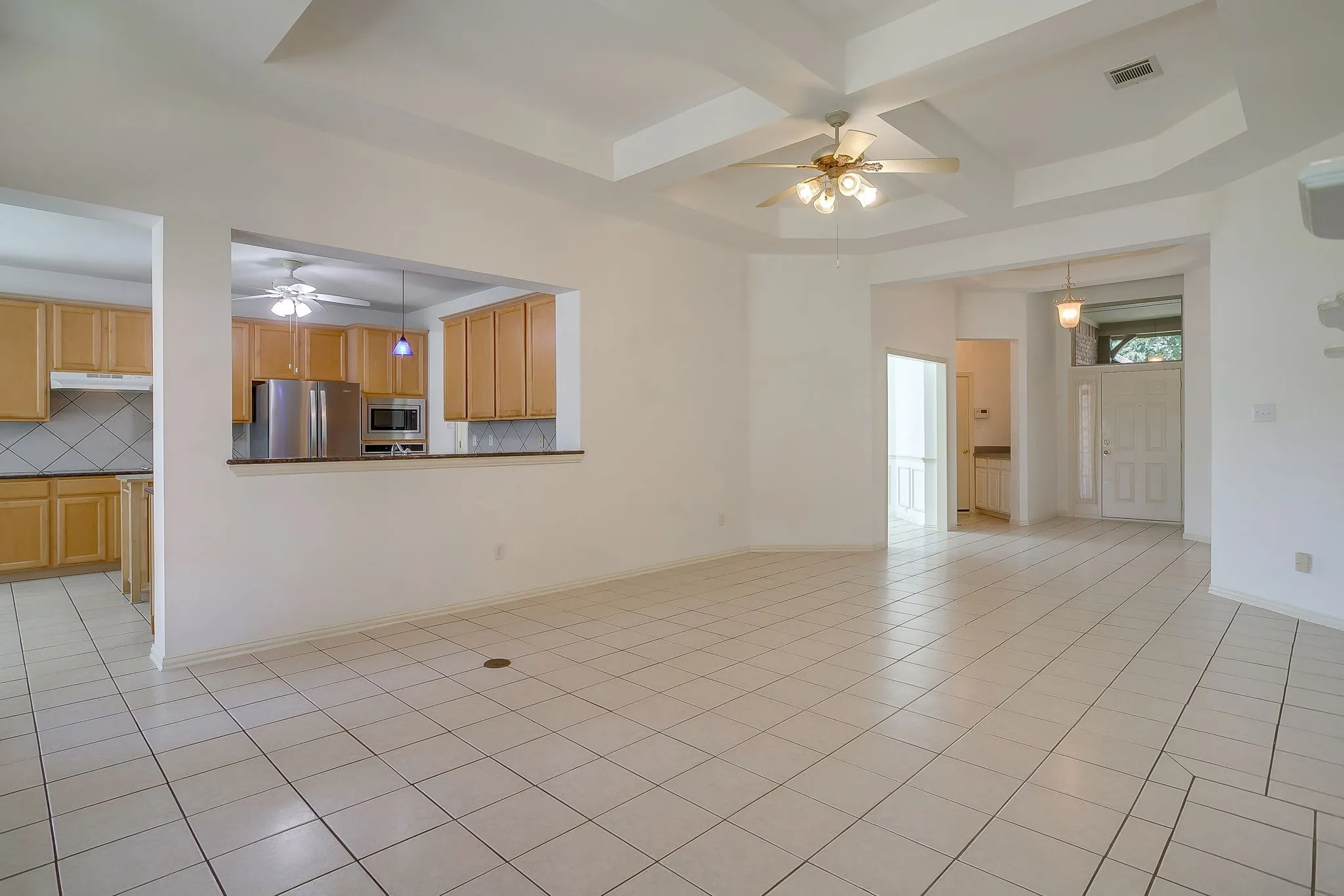 View from living room into kitchen and foyer.