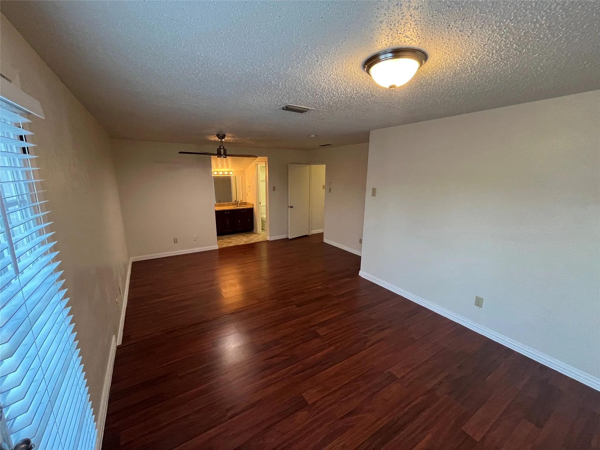 Wood-finish flooring throughout, ceiling fan, window blinds, and recessed lighting