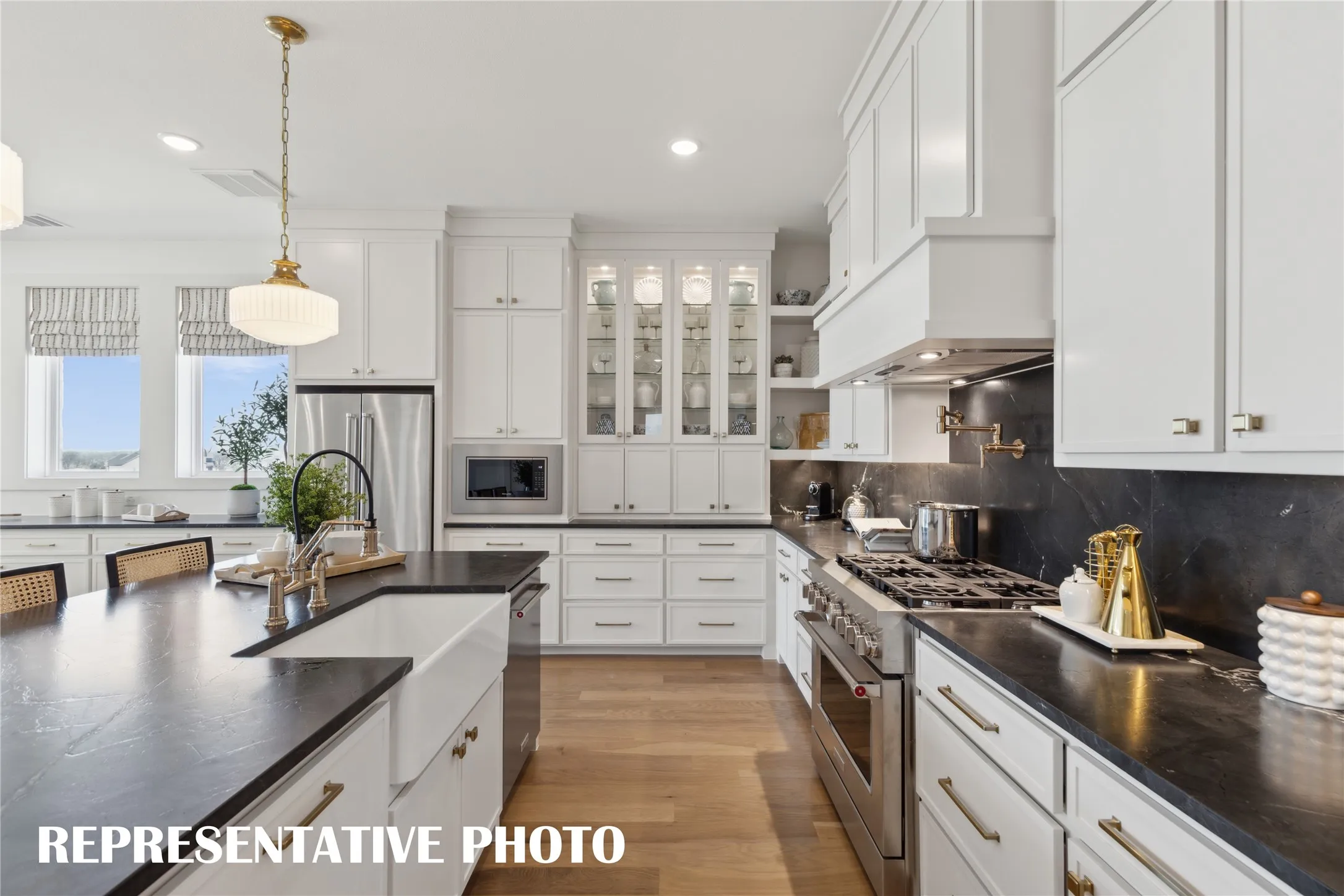 Gorgeous counter tops, beautiful cabinetry and lovely flooring paired with contemporary stainless steel all combine to create this timeless kitchen!  REPRESENTATIVE PHOTO
