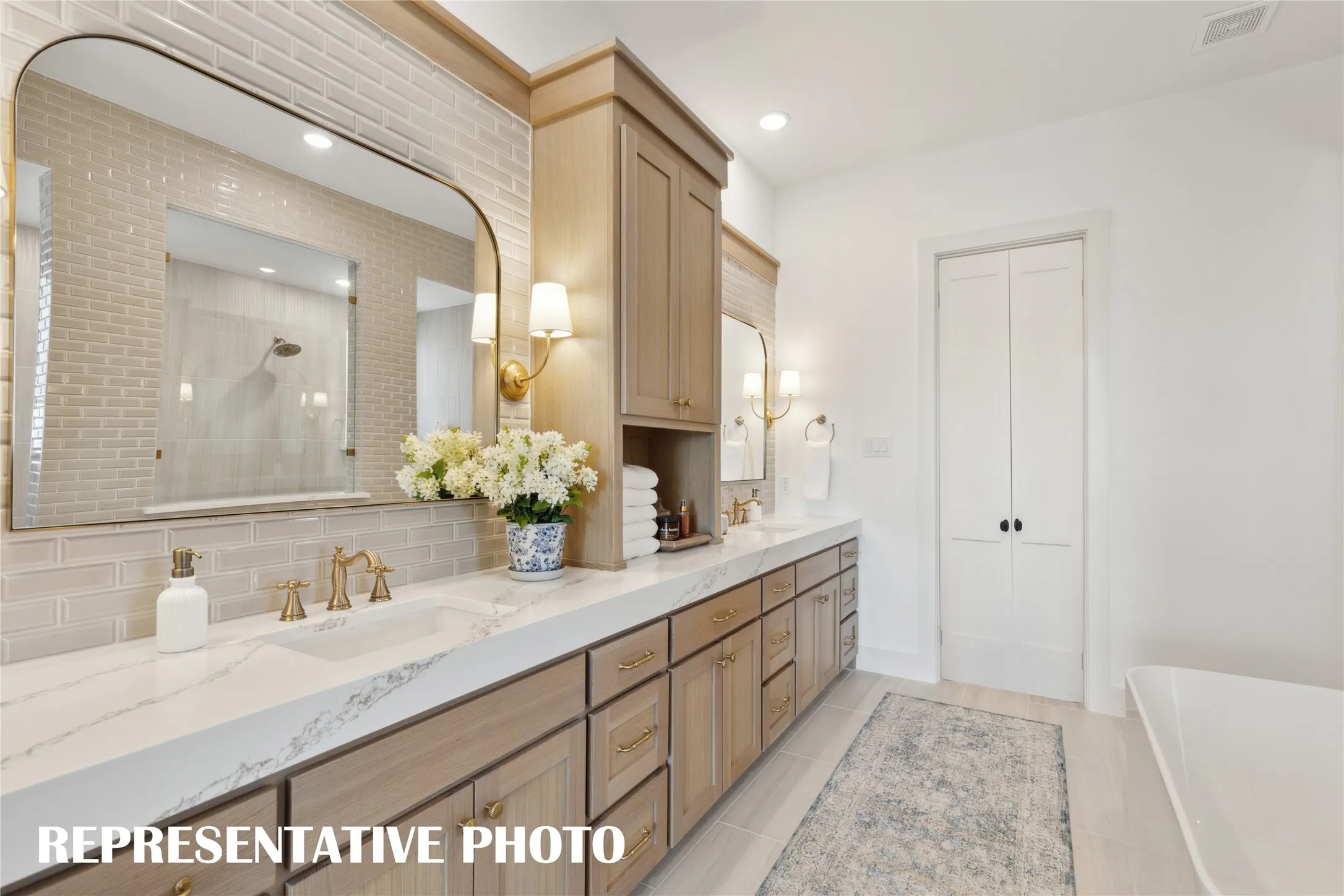 No shortage of space or style in this dream owner's bath which features our signature walk through shower with freestanding tub.  REPRESENTATIVE PHOTO