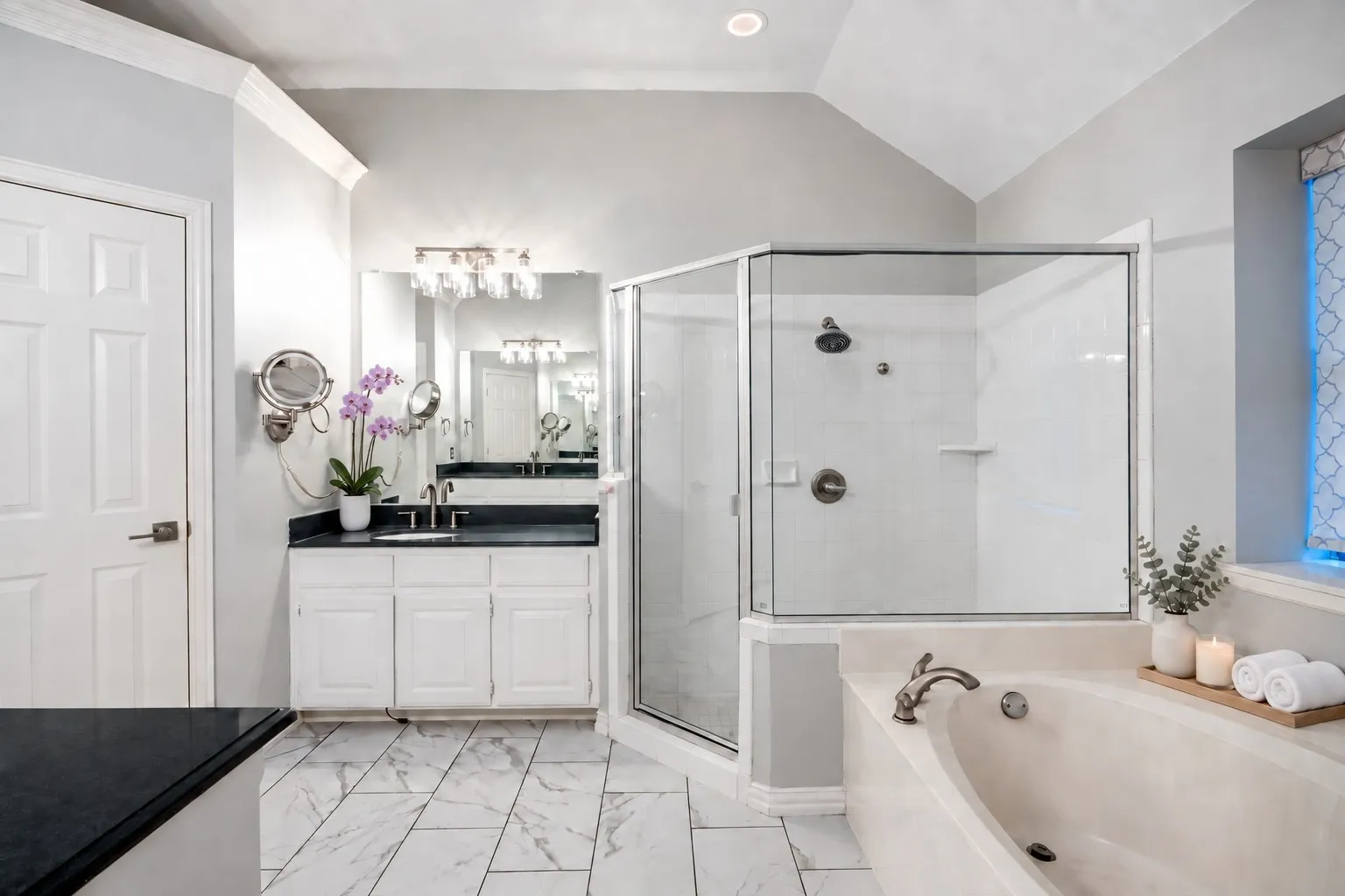 Primary bath has separate sinks, garden tub and walk in shower.  The door is to the power room and the primary closet door is to the left of that.