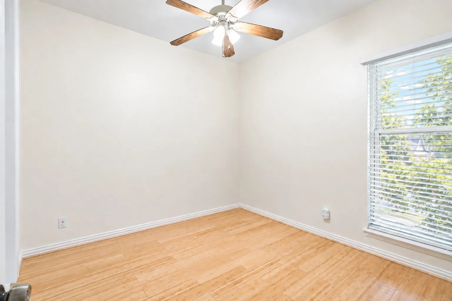 4th bedroom/office with a walk in closet, window and ceiling fan. Newly painted with alabaster satin.