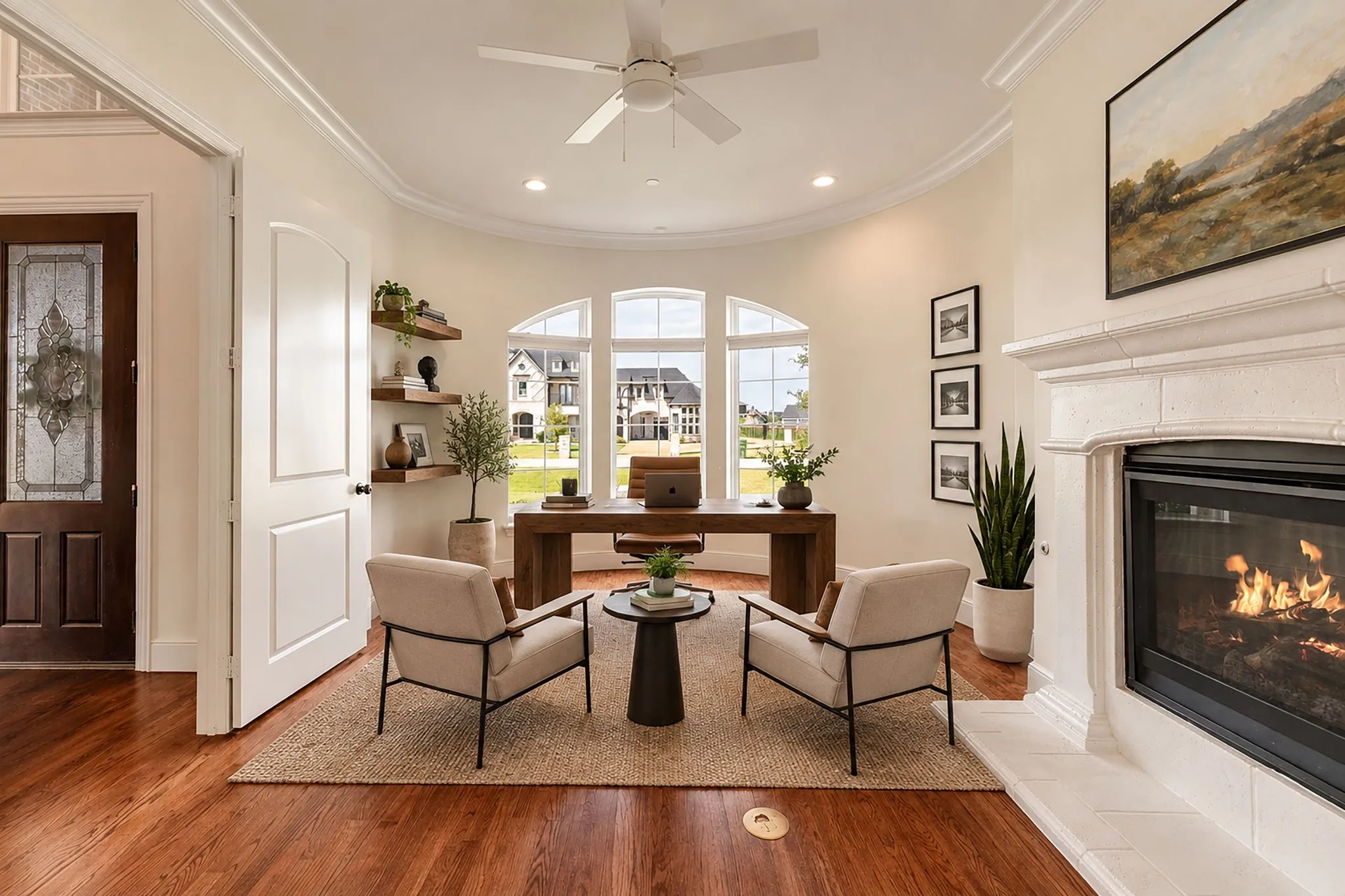 Study virtually staged, Hardwood flooring throughout, recessed lighting, and a white ceiling fan