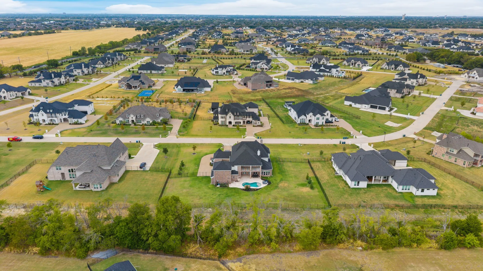 Expansive residential community featuring diverse architectural styles, landscaped lots, and established street infrastructure
