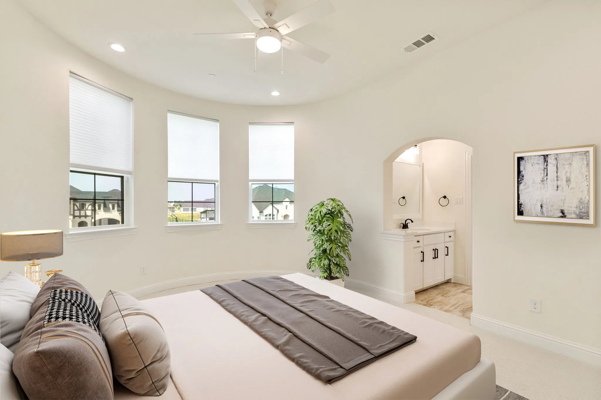 Bedroom virtually staged, Curved wall with three windows, a ceiling fan, and recessed lighting
