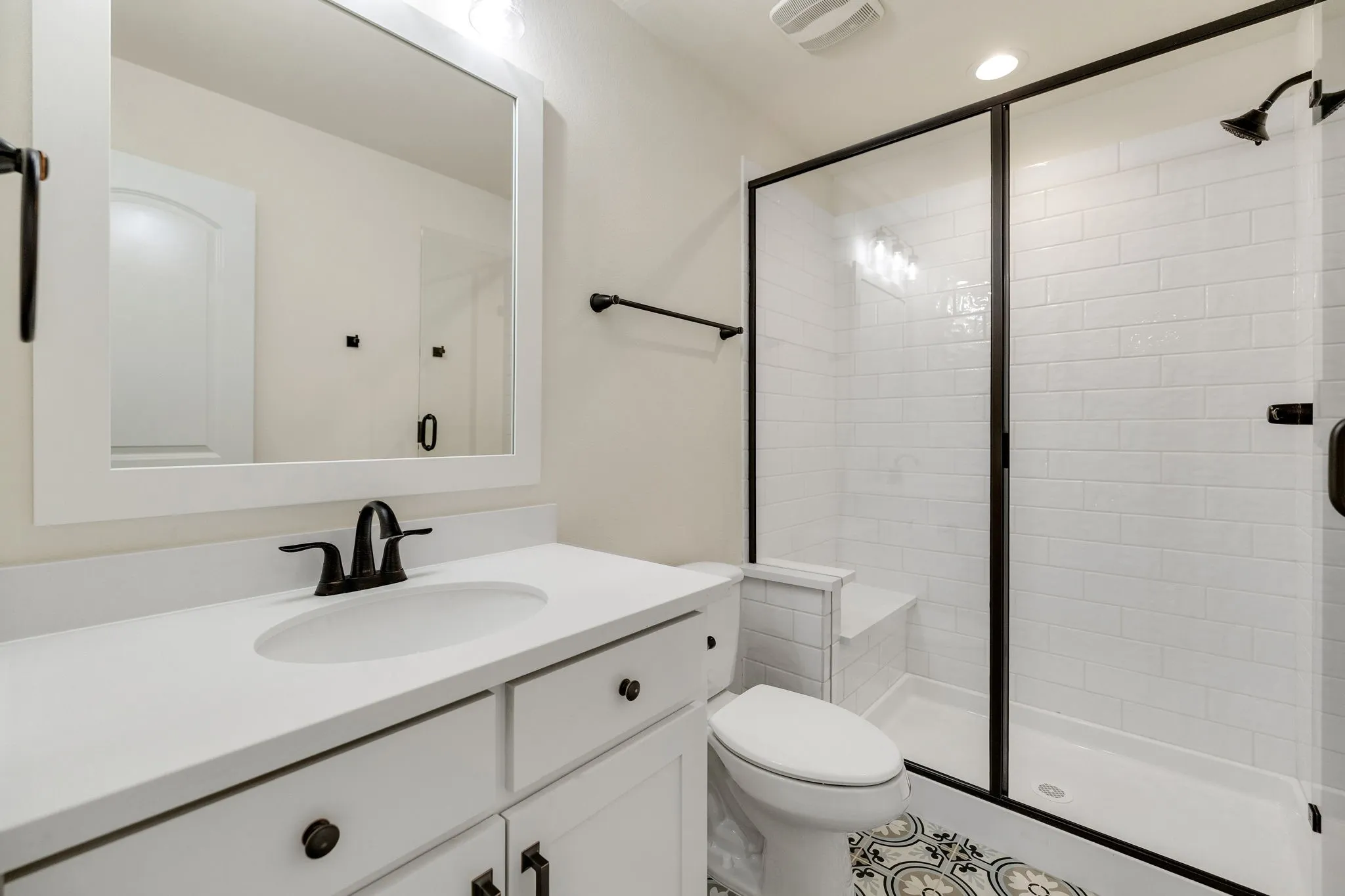 White vanity with undermount sink and matte black faucet