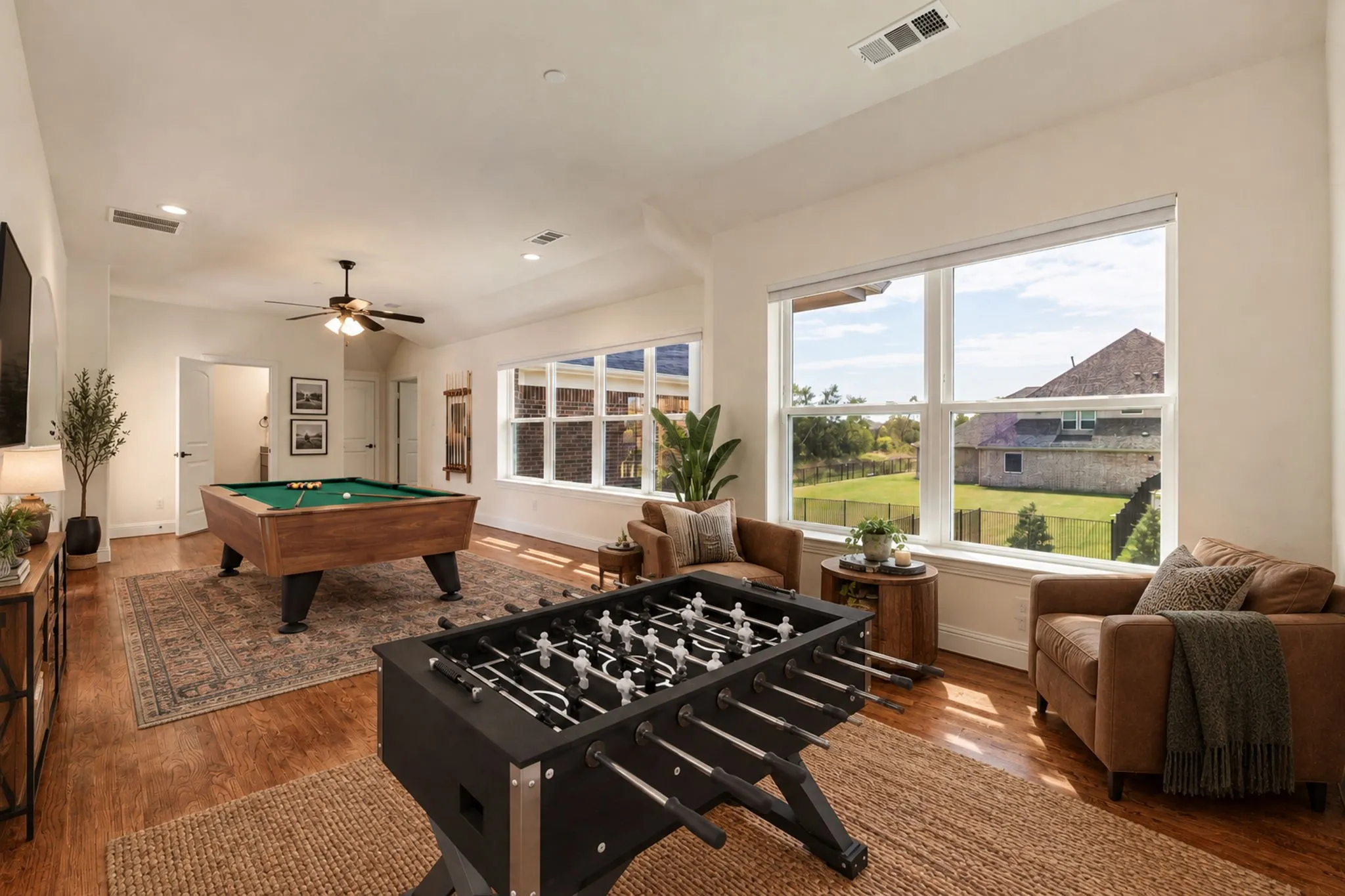 Game Room virtually staged, Spacious room with wood-finish flooring, recessed lighting, and a ceiling fan