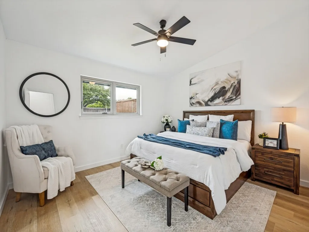 Vaulted ceilings, wood-finish flooring, and a contemporary ceiling fan with integrated lighting