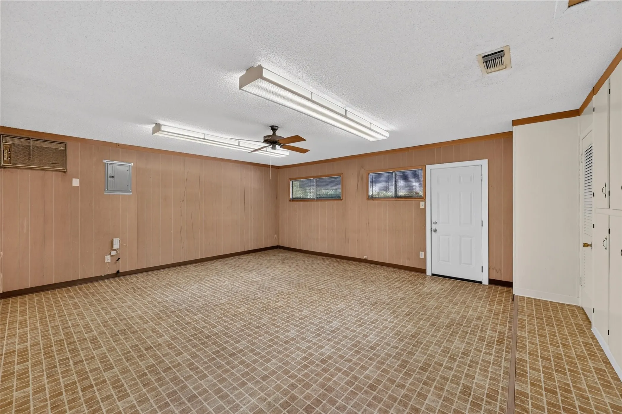 So much space for creativity in this bonus room. Ahead is an exterior door leading to the carport in the backyard