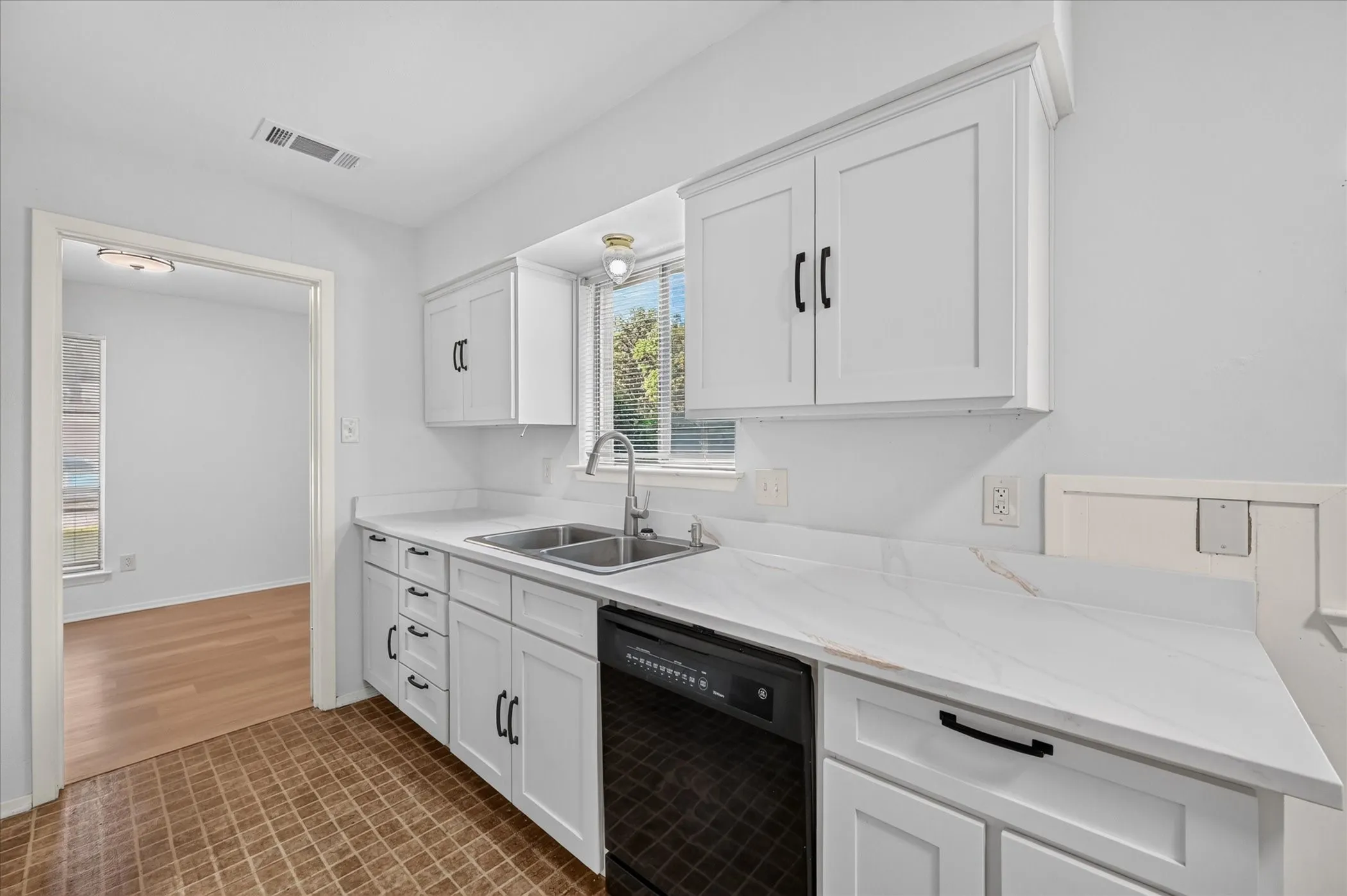 Kitchen recently updated with quartz countertops, a section of butcher block, and cabinets