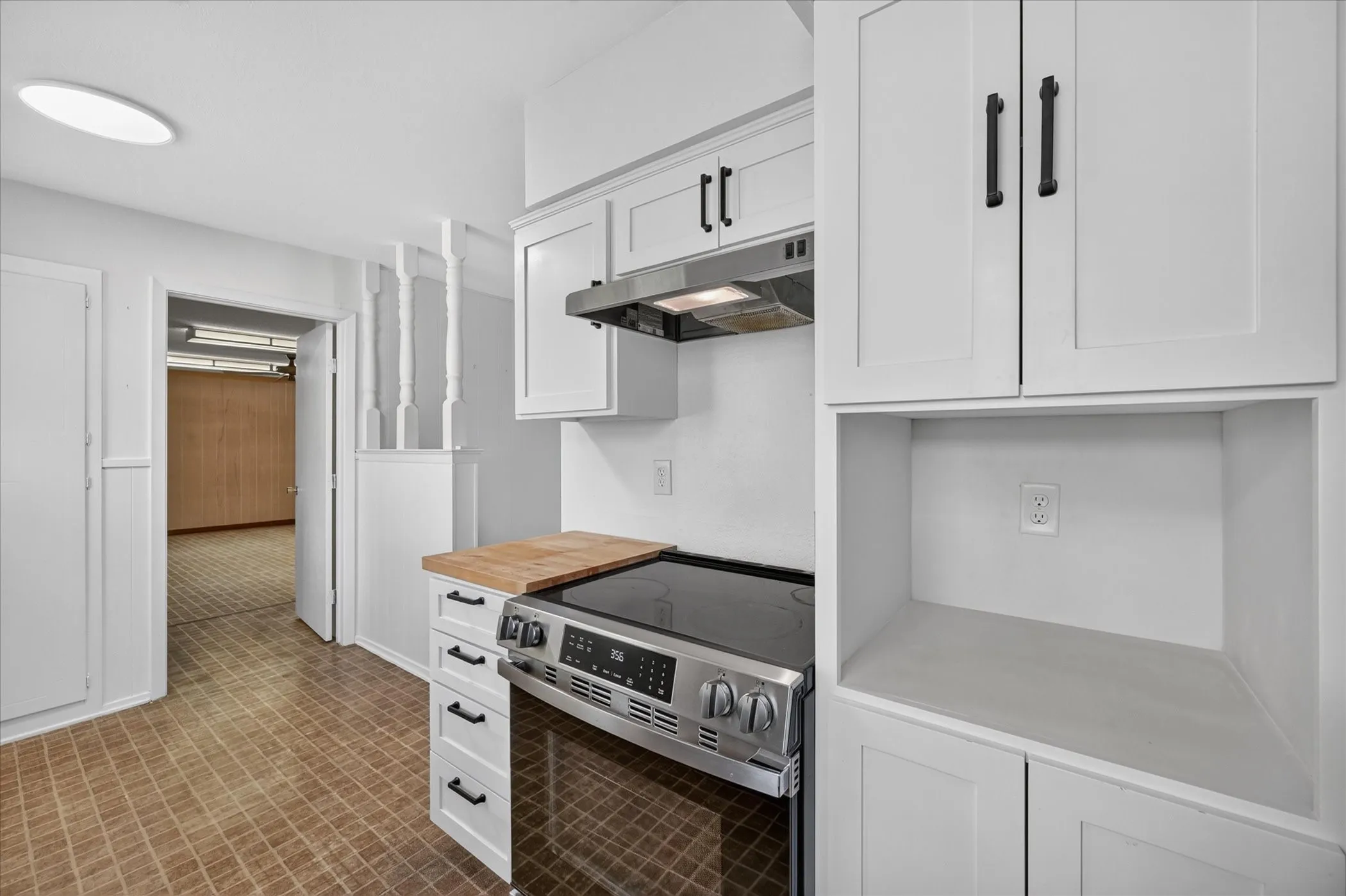Kitchen recently updated with quartz countertops, a section of butcher block, and cabinets