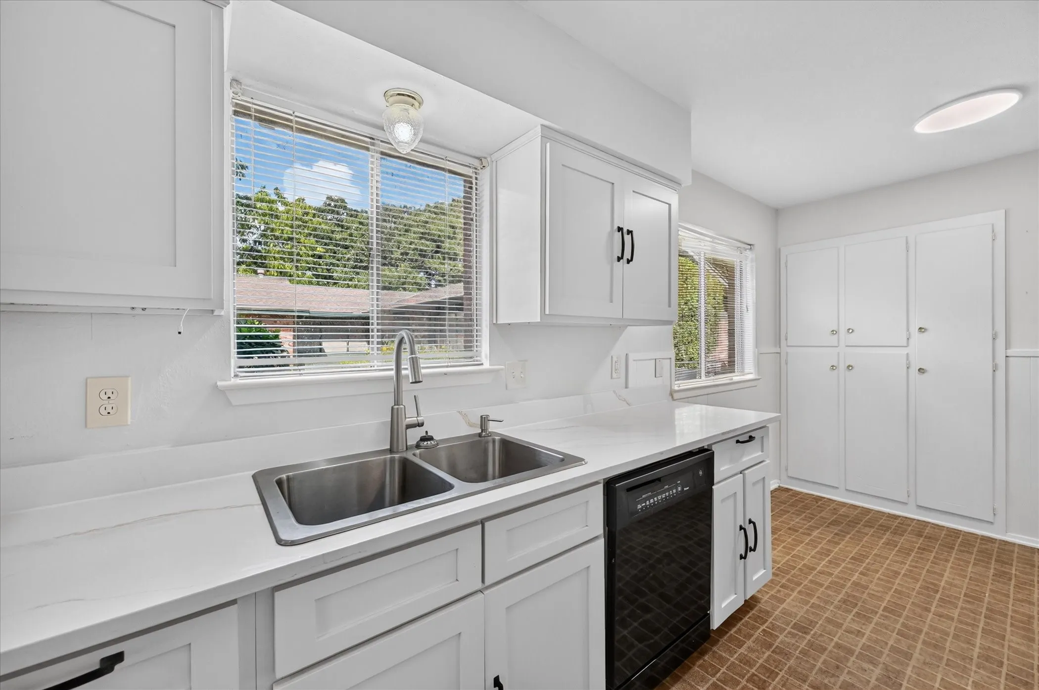 Kitchen recently updated with quartz countertops, a section of butcher block, and cabinets