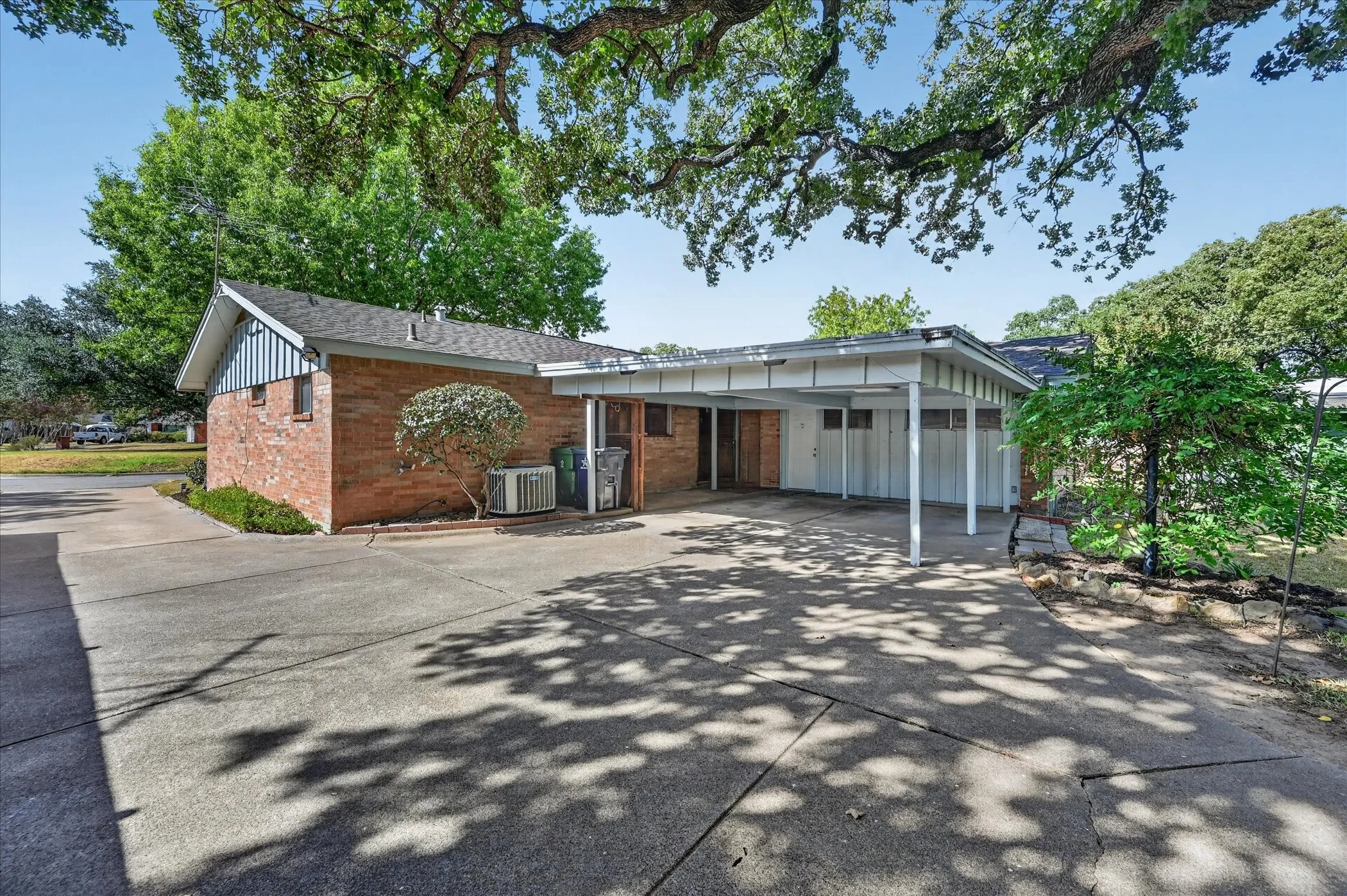 Plenty of parking and an attached carport for 2 vehicles. When not in use as a carport, the carport can serve as an excellent covered porch for the large backyard.