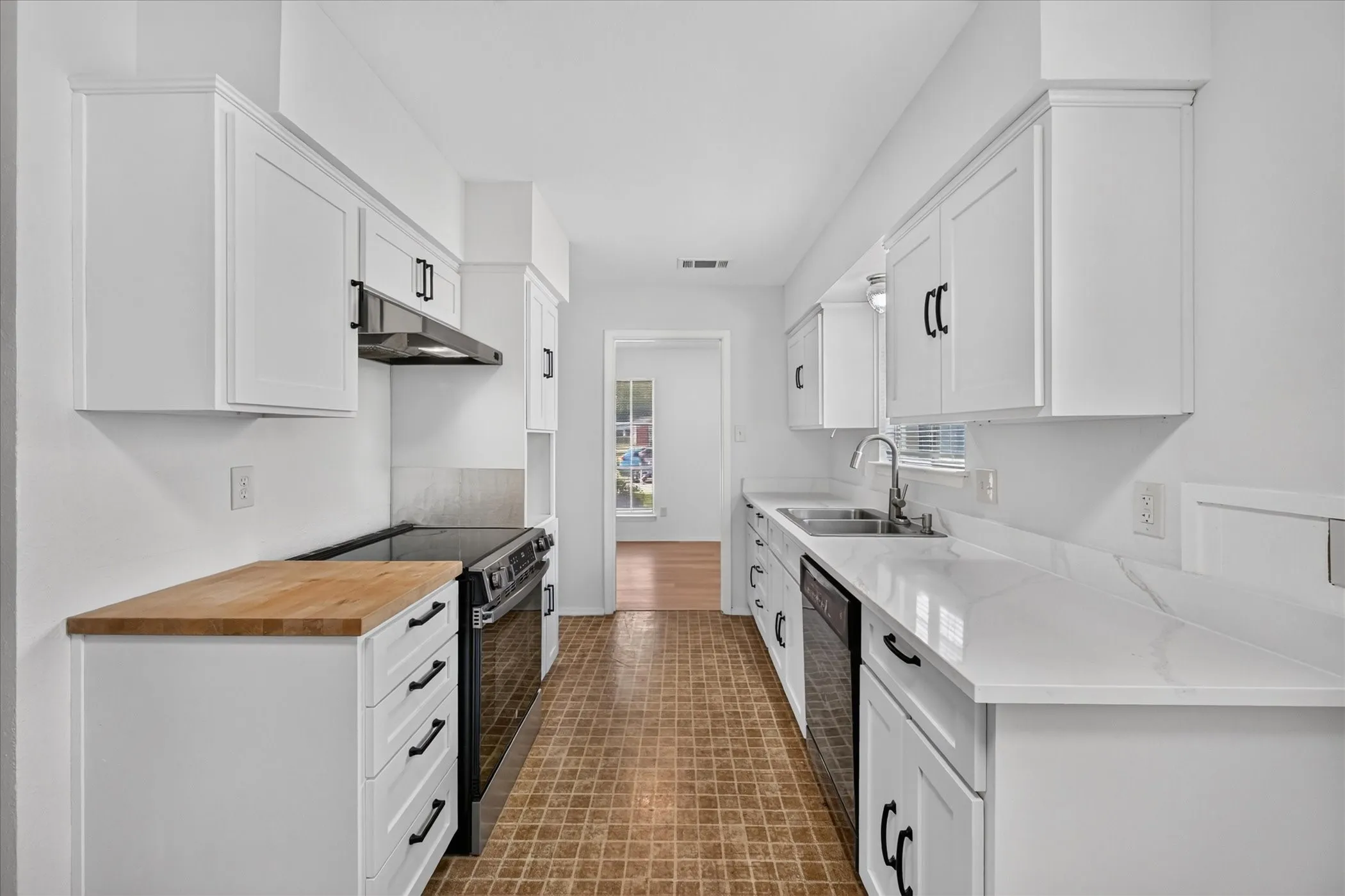 Kitchen recently updated with quartz countertops, a section of butcher block, and cabinets