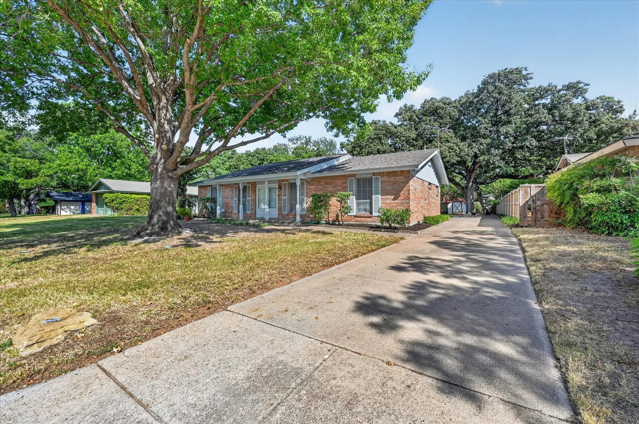 Extended driveway that takes you to the carport in the rear that covers 2 cars. Plenty of parking!