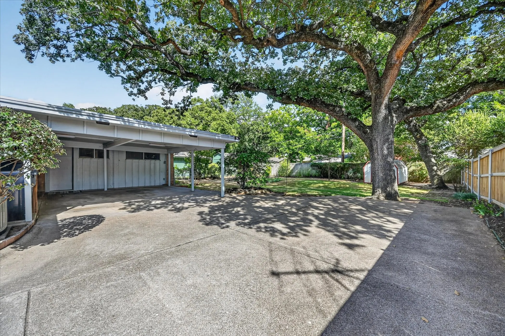 Plenty of parking and an attached carport for 2 vehicles. When not in use as a carport, the carport can serve as an excellent covered porch for the large backyard.