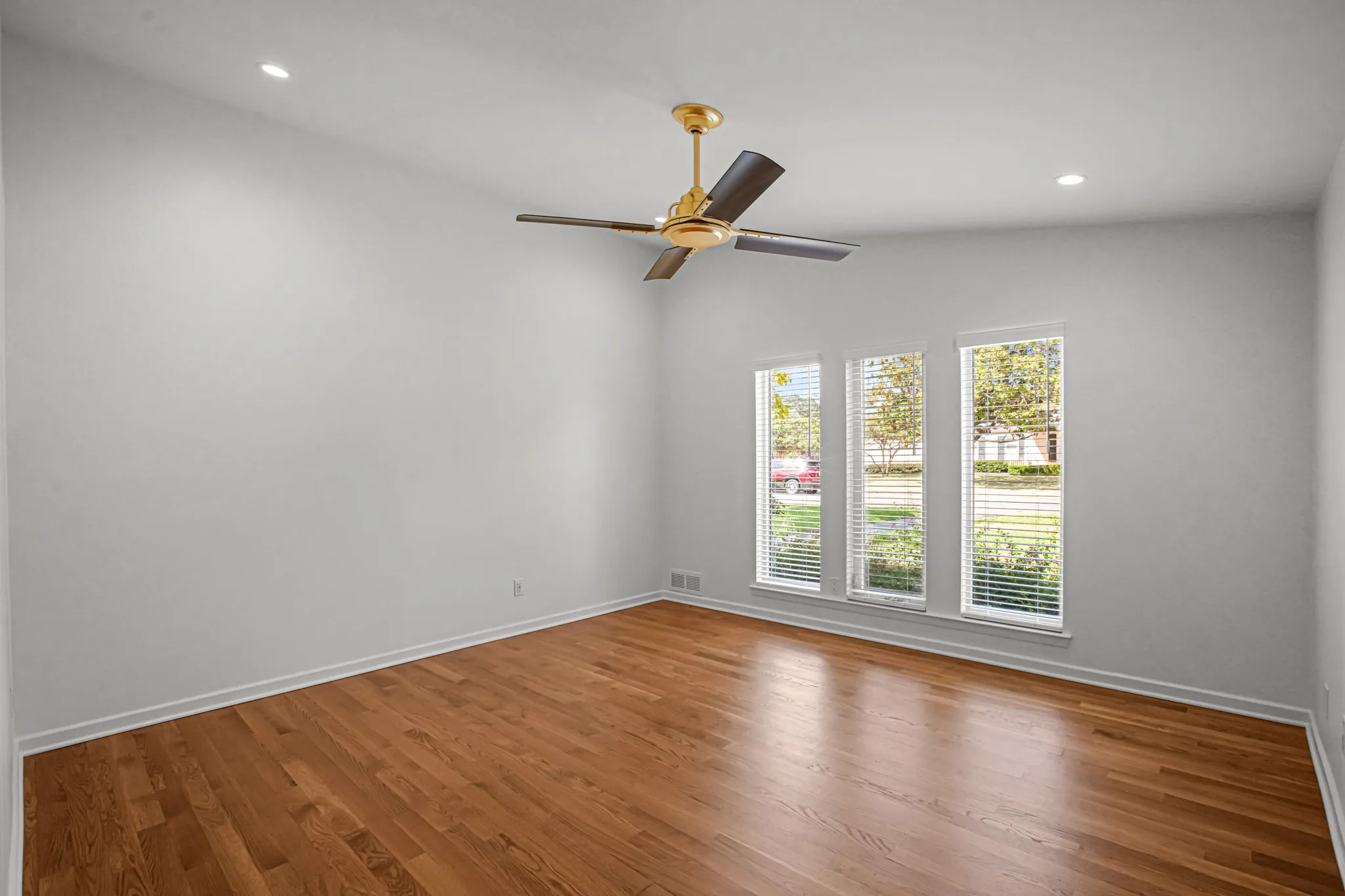 Bedroom Two with hardwood flooring, ceiling fan, Jack-n-Jill Bath.