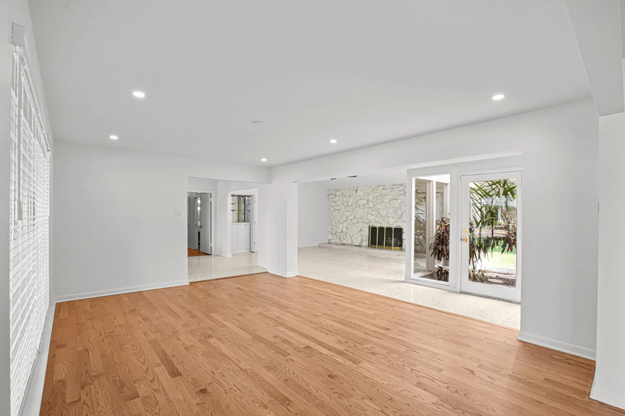 Hardwood flooring throughout, recessed lighting, and white window blinds