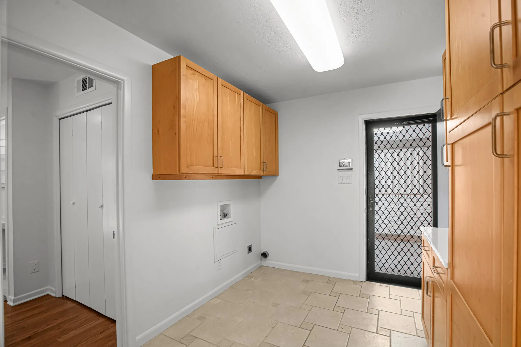 Great laundry area with built-ins and quartz counters.  The door leads to the one-car garage, so bringing in groceries is convenient!