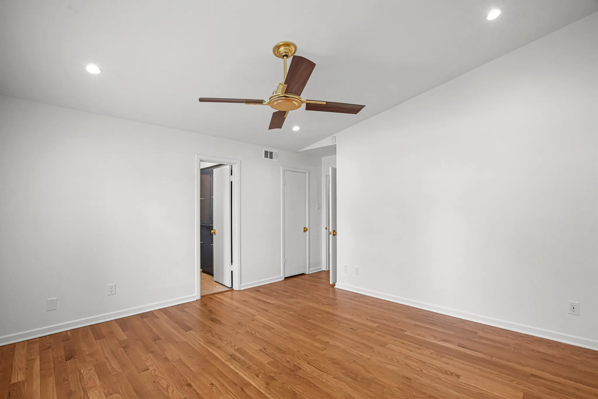 Bedroom 2 with hardwood flooring, remote controlled ceiling fan, walk-in closet and shares Jack-n-Jill bath with Bedroom 3.