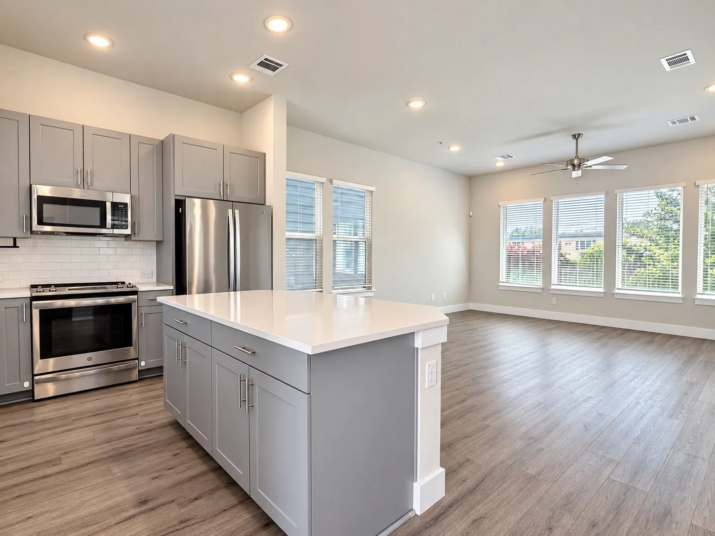 Contemporary kitchen with grey cabinetry and stainless steel appliances