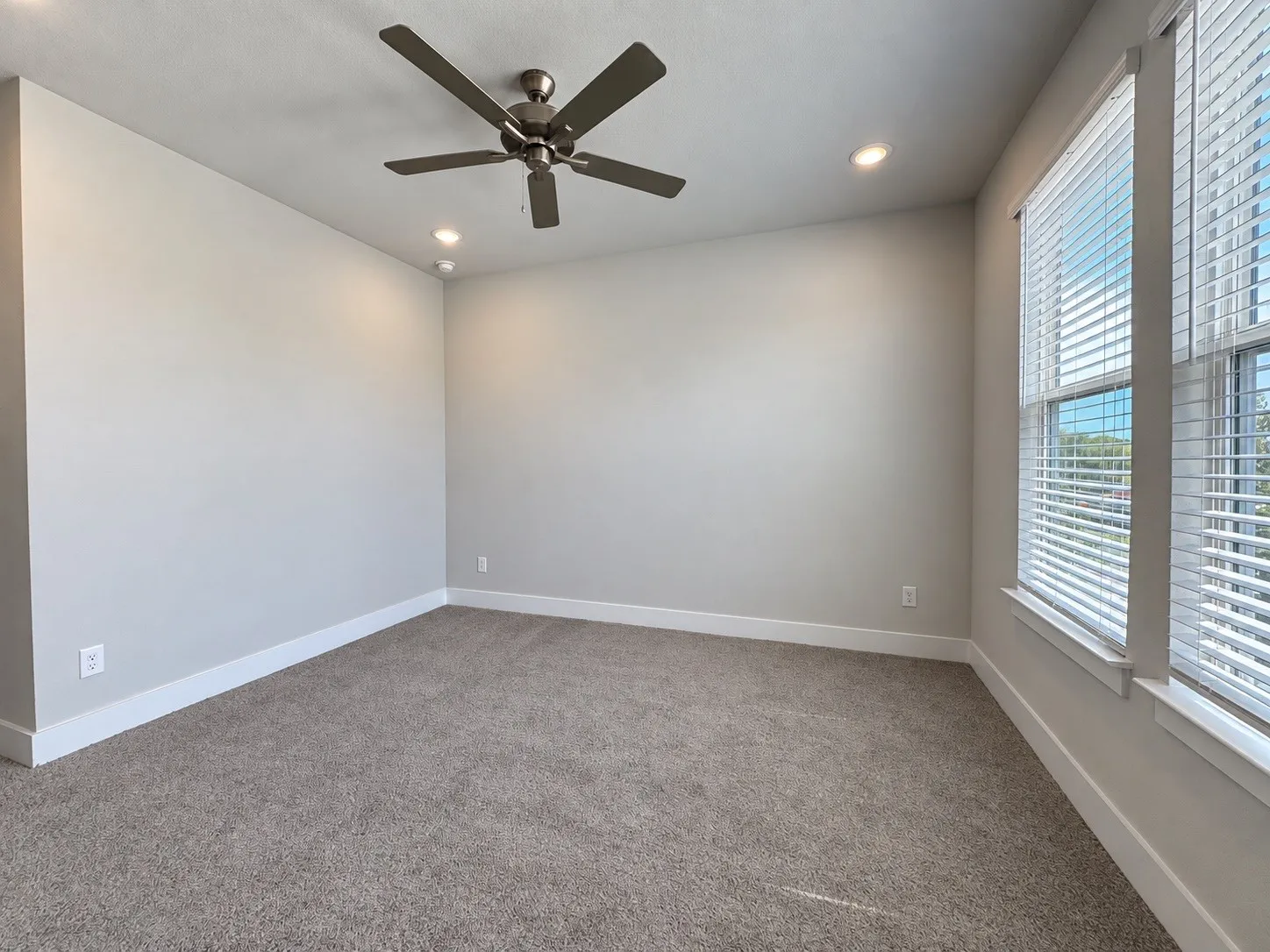 Carpeted flooring, recessed lighting, ceiling fan, and window with blinds