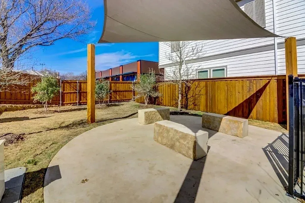 Circular concrete patio with built-in stone seating