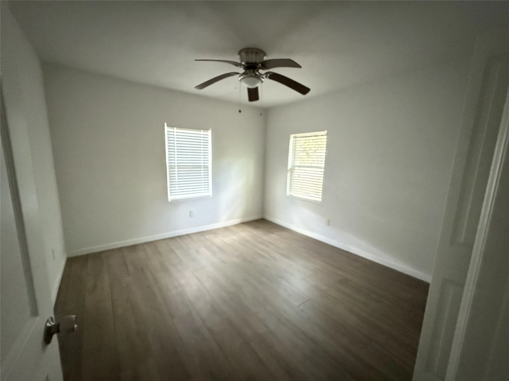 Wood-finish flooring with white baseboards