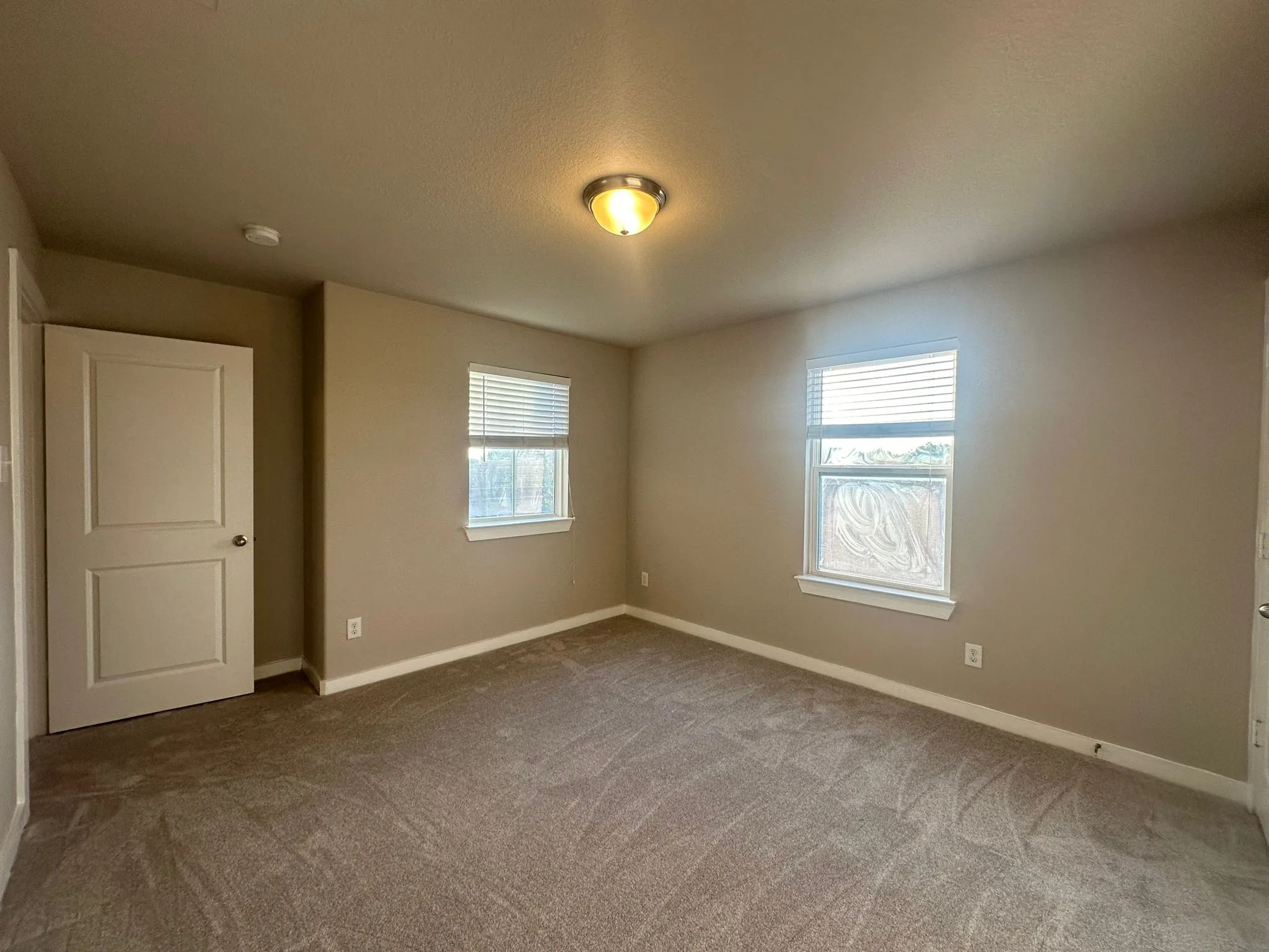 Neutral-toned walls complement plush carpeting