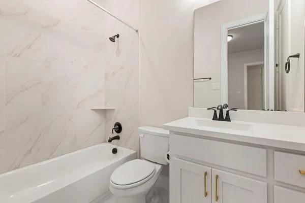 White vanity with gold-finish hardware and integrated sink