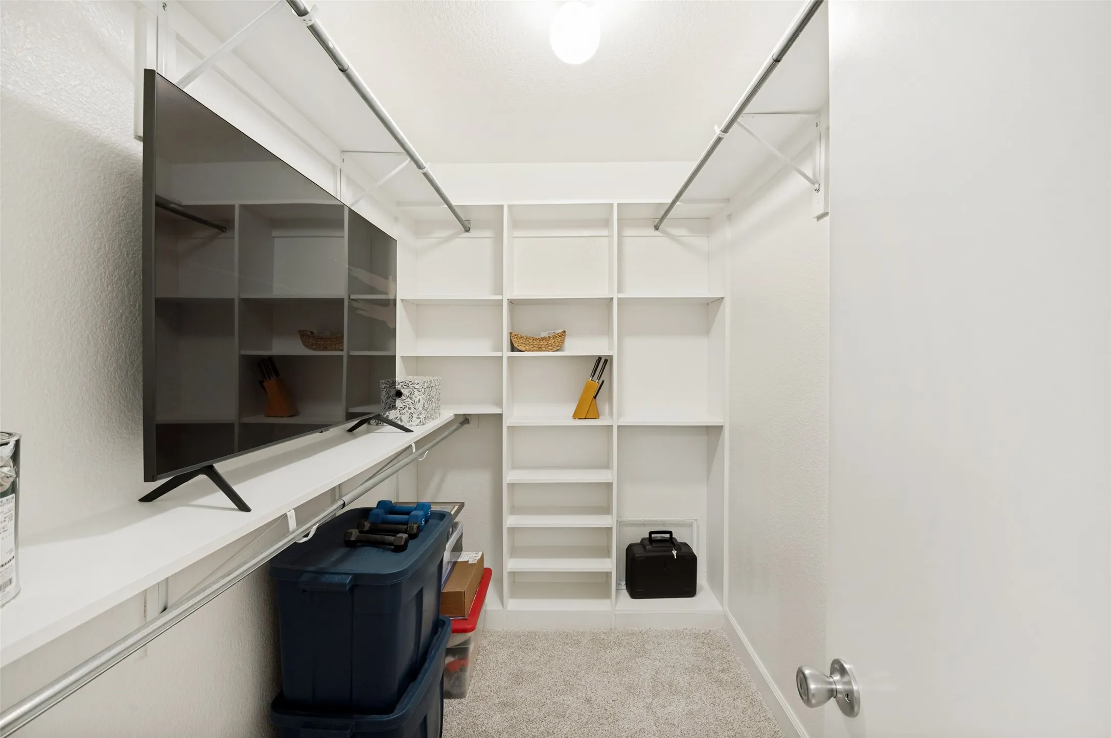 One of the standout features of the primary suite is the expansive walk-in closet, conveniently accessed through the ensuite bath. Designed for exceptional organization, this oversized space features extensive built-in shelving, hanging areas, and abundant storage for clothing, shoes, accessories, and more.