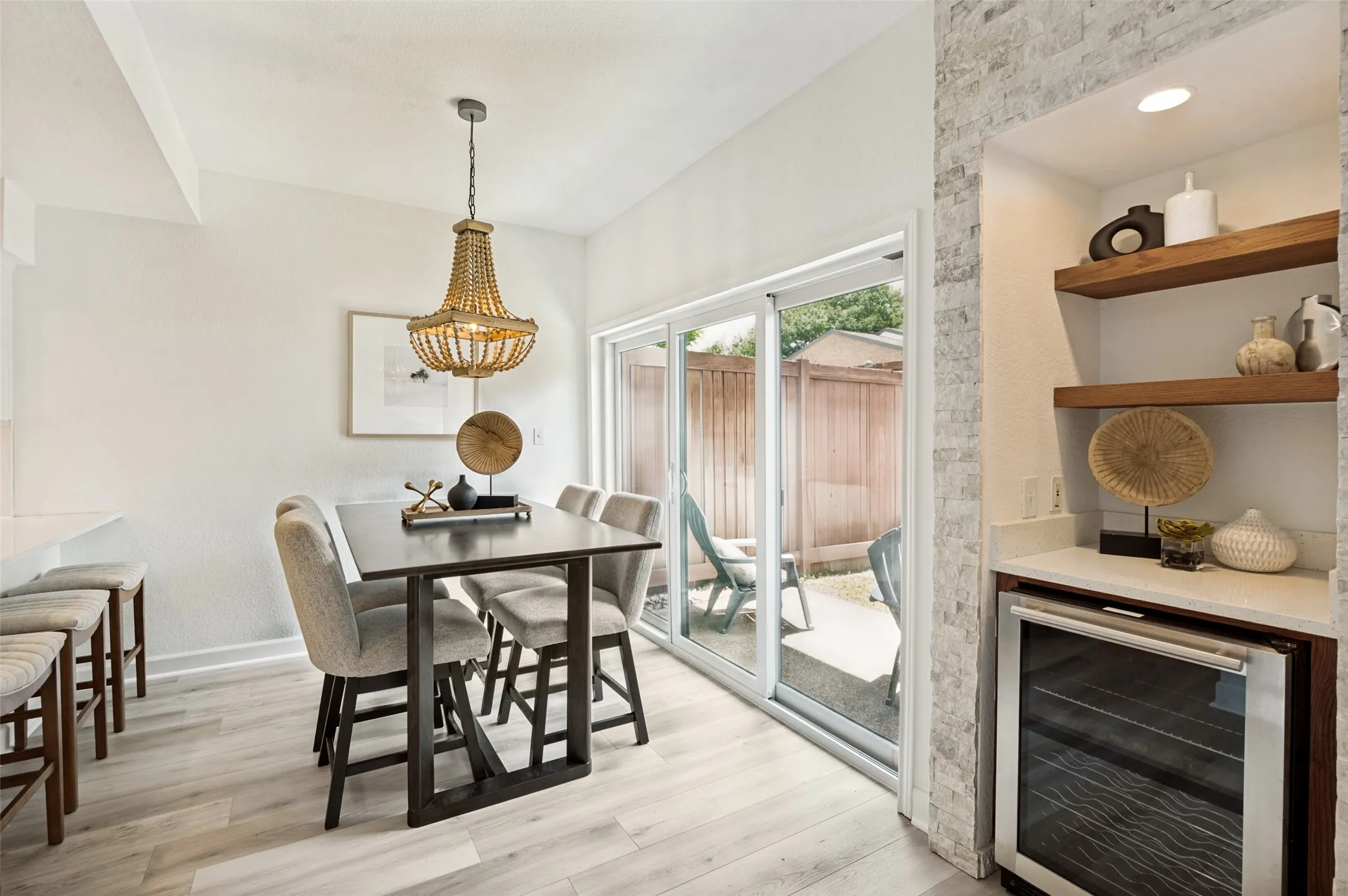 
This light-filled dining area offers the perfect setting for both casual meals and entertaining. Expansive sliding glass doors bathe the space in natural light and create a seamless connection to the private patio, extending your living and dining space outdoors.
