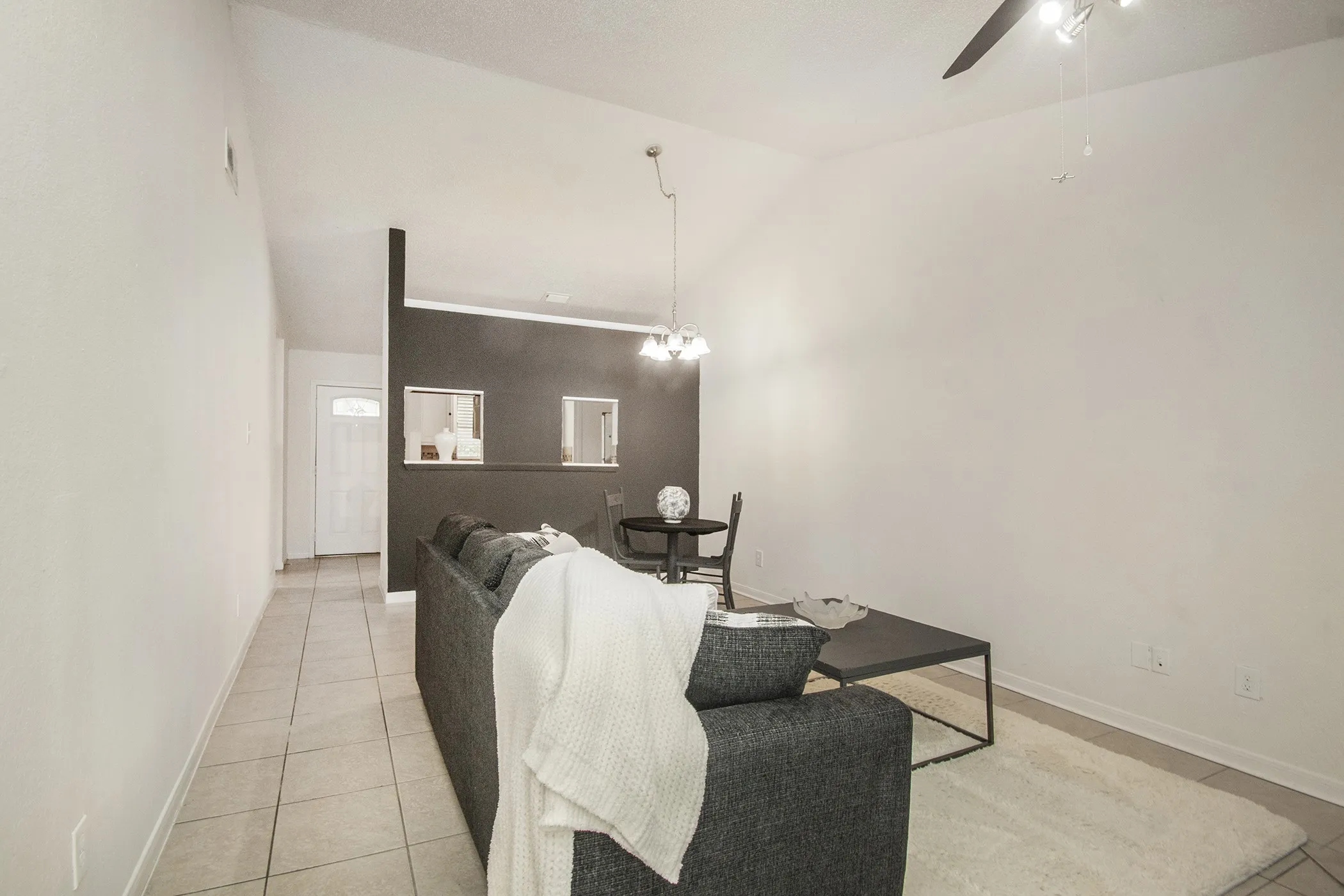 Vaulted ceiling with a ceiling fan, recessed lighting, and tile flooring