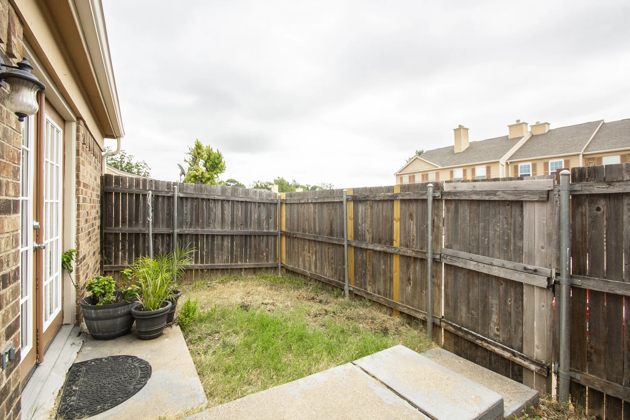 Private outdoor space with wood fencing and a concrete patio