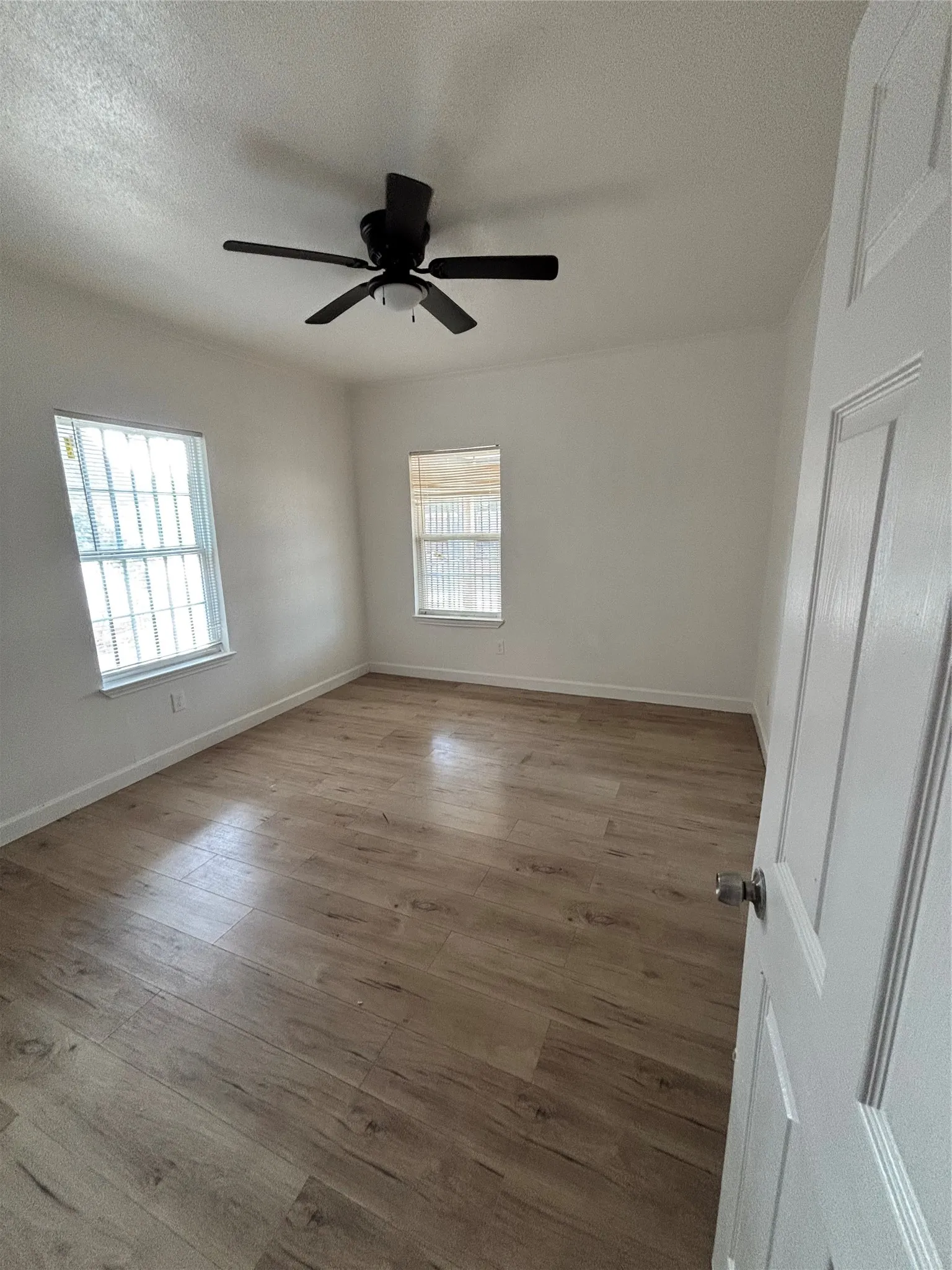 Neutral wall tones complement wood-finish flooring