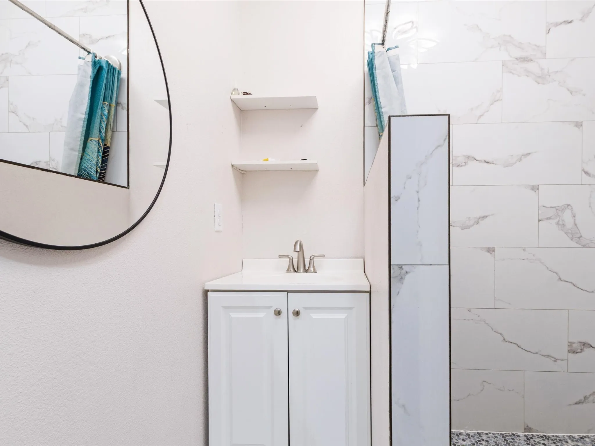 Vanity with white shaker cabinetry, white countertop, and brushed nickel faucet