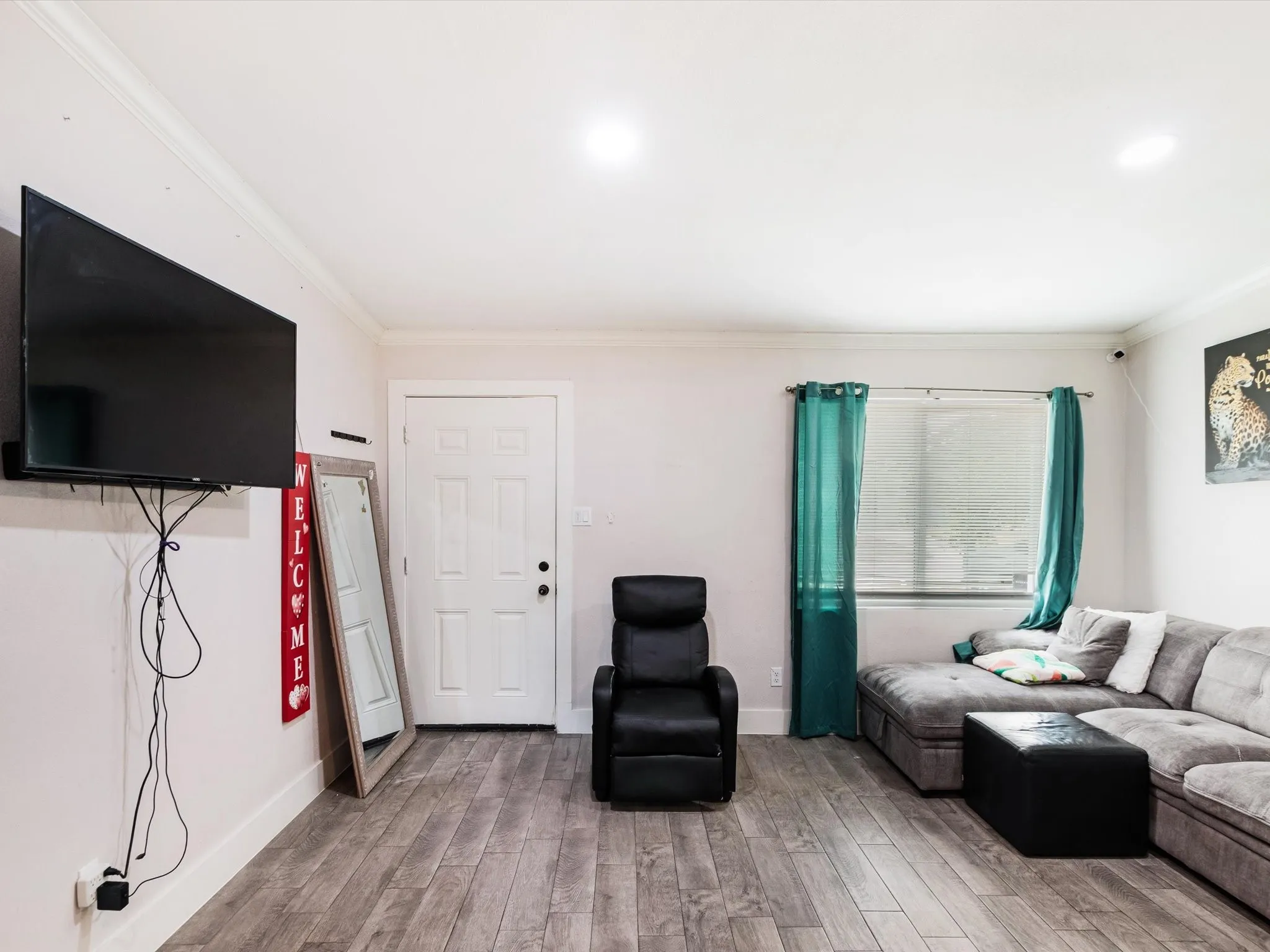 Wood-finish flooring, recessed lighting, crown molding, white trim, and a window with blinds