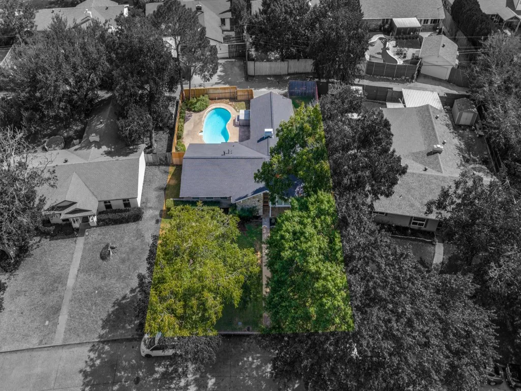 Outdoor swimming pool, fenced backyard, mature trees, gabled roofline, additional storage shed