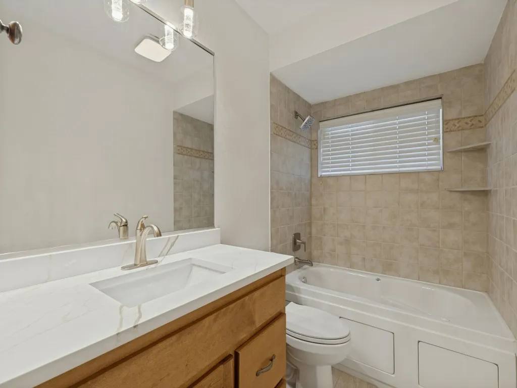 Vanity with white countertop, integrated sink, and brushed nickel faucet