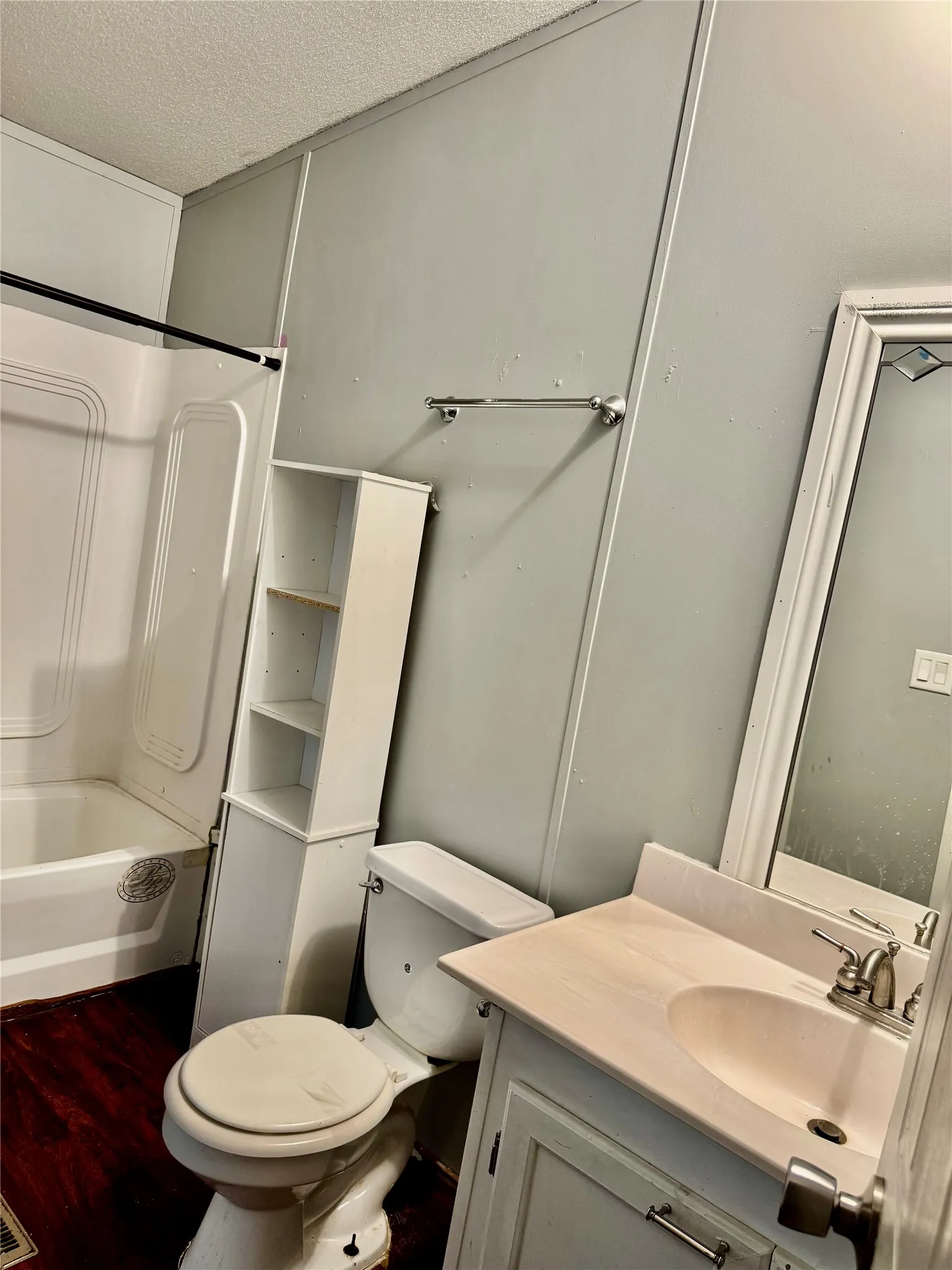 Bathroom featuring a white vanity with an integrated sink, chrome faucet, and a wall-mounted mirror
