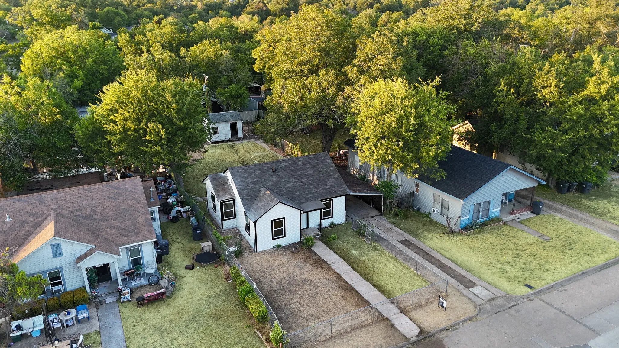 Pitched rooflines, multiple residential structures, and mature surrounding trees