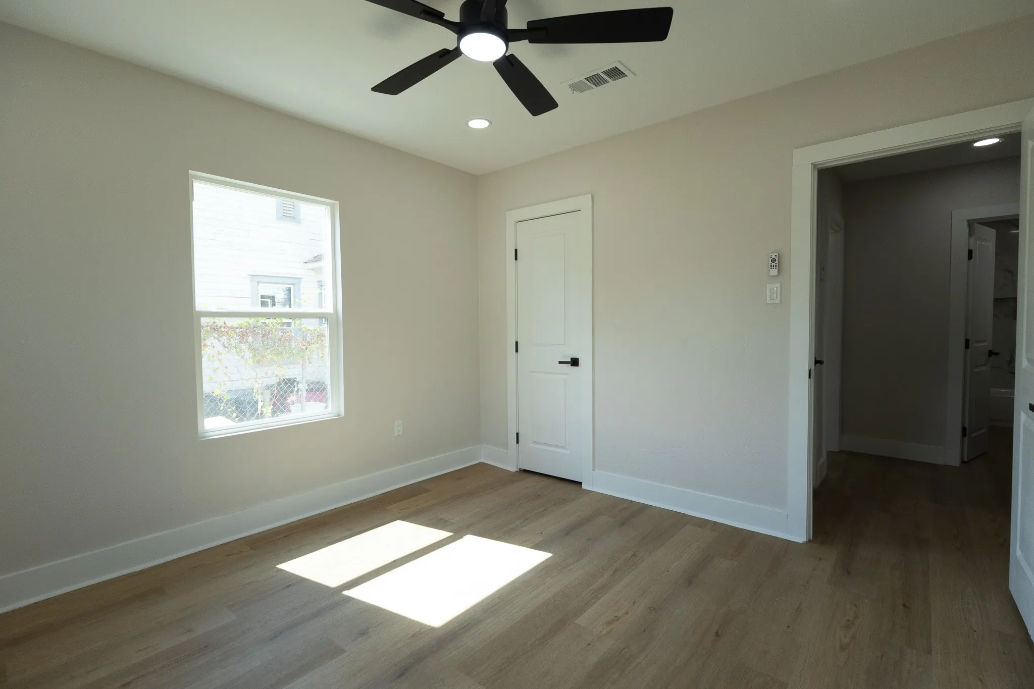Wood-finish flooring, recessed lighting, and a ceiling fan with integrated lighting